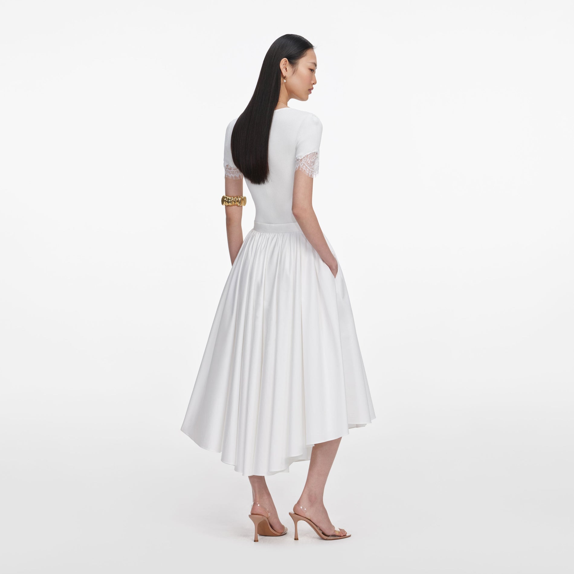 Back view of a woman wearing the White Cotton Poplin Midi Skirt