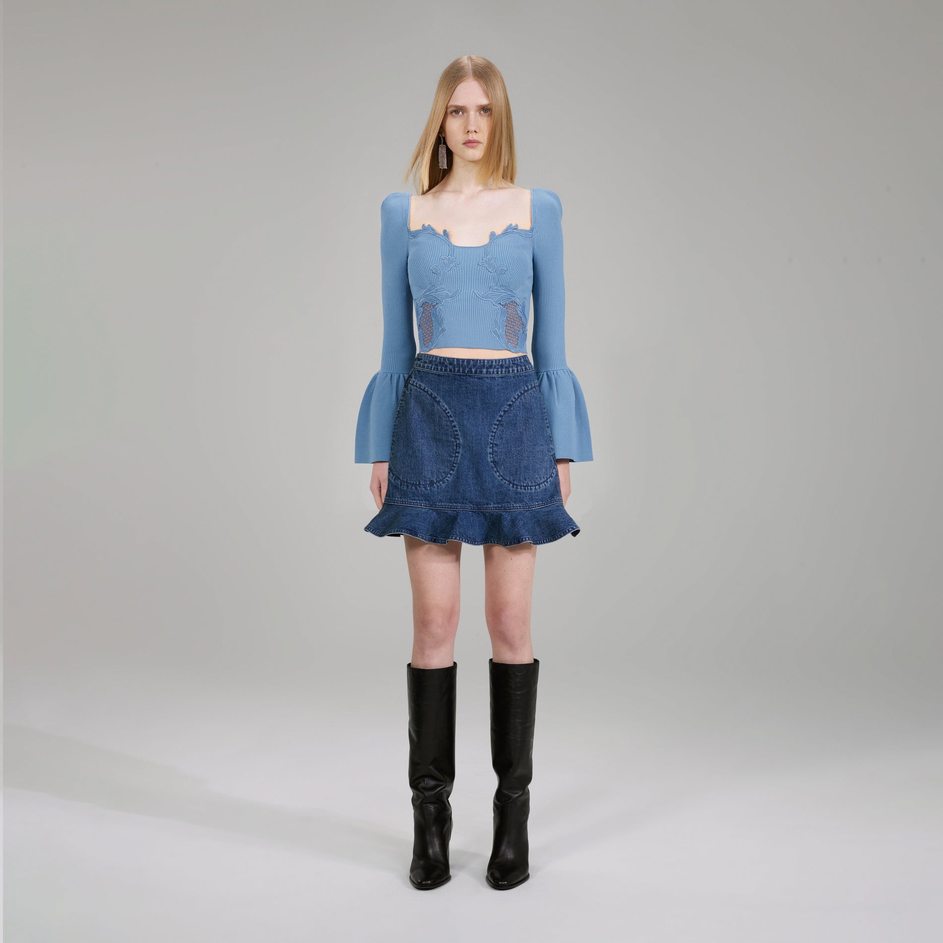 A woman wearing the Pastel Blue Lace Insert Ribbed Knit Top