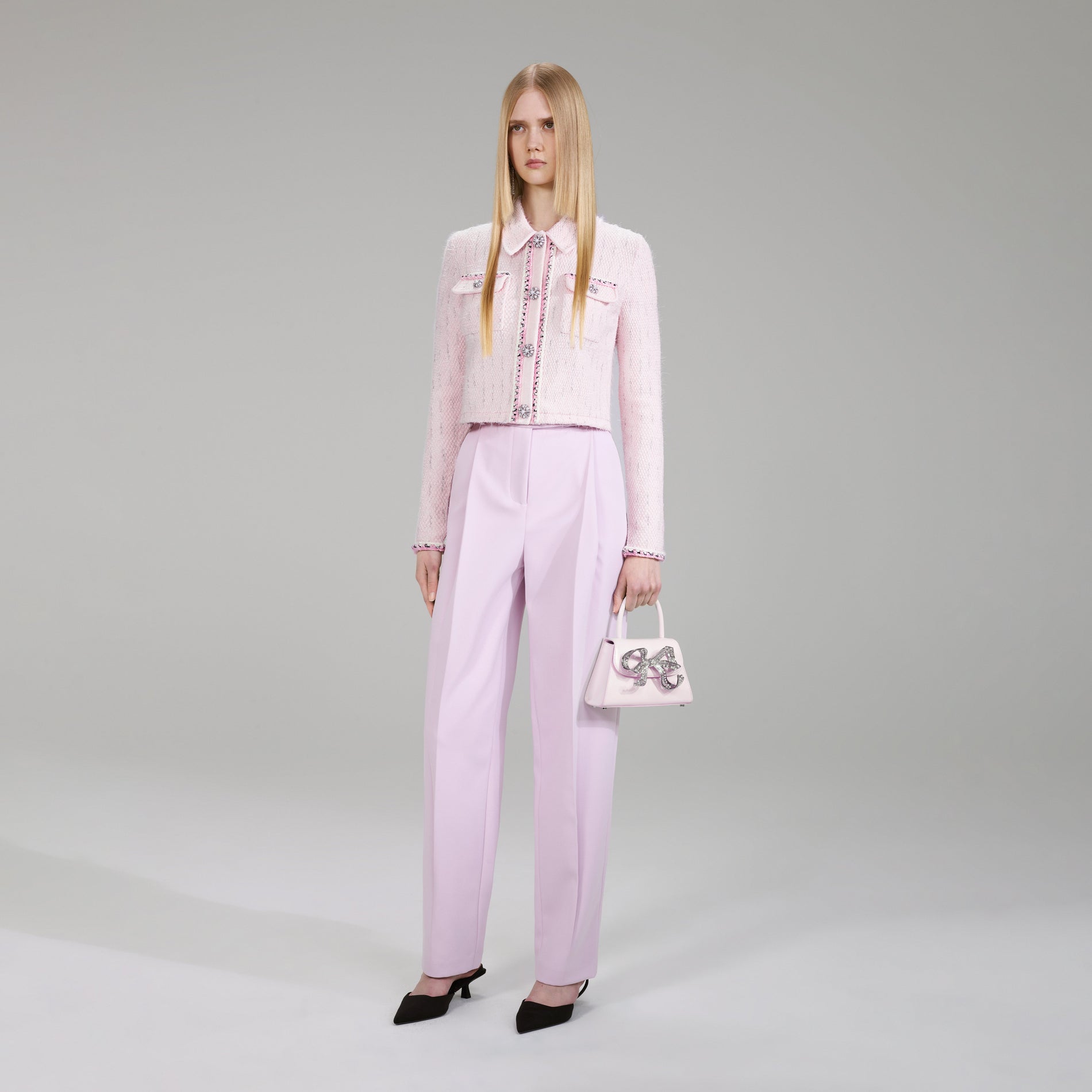 A woman wearing the Pink Melange Knit Cardigan