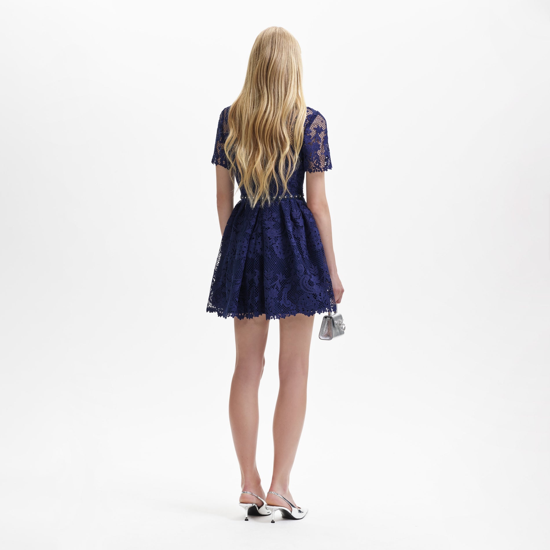 Back view of a woman wearing the Navy Lace Embellished Mini Dress