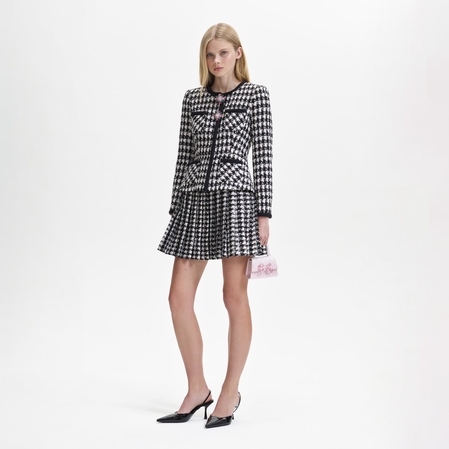 Side view of a woman wearing the Black Check Boucle Mini Jacket Dress