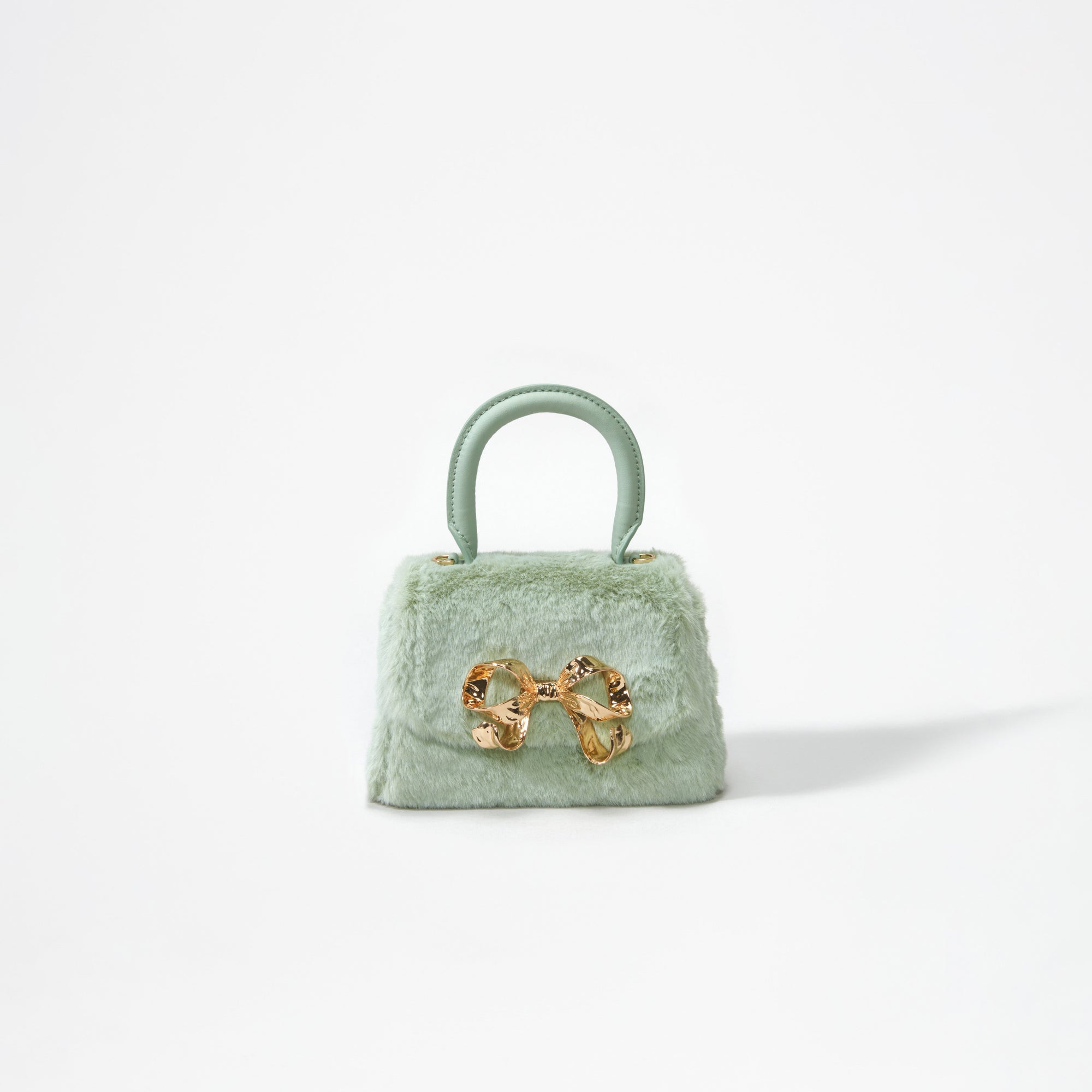 A woman wearing the Green Fluffy Bow Micro Bag