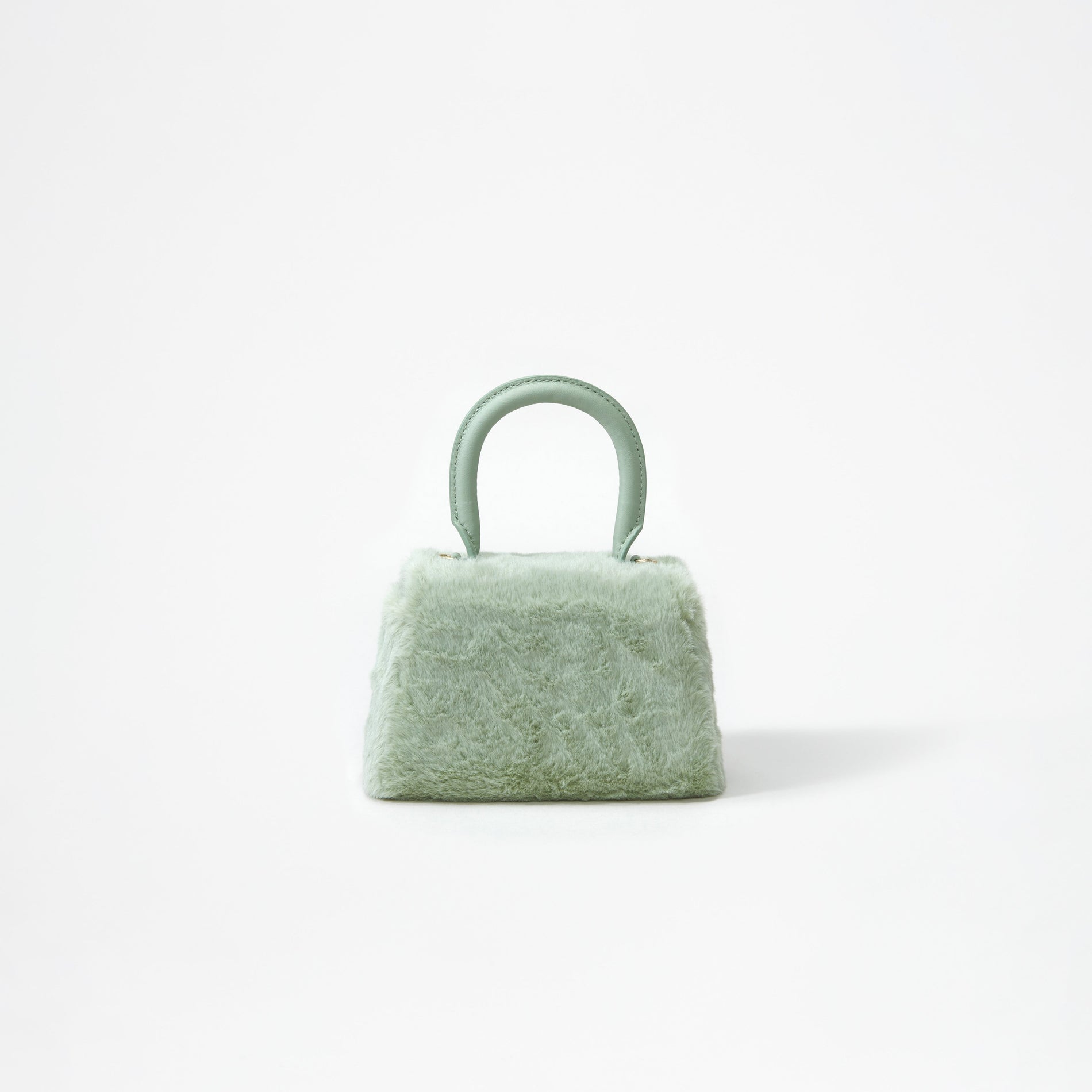 A woman wearing the Green Fluffy Bow Micro Bag