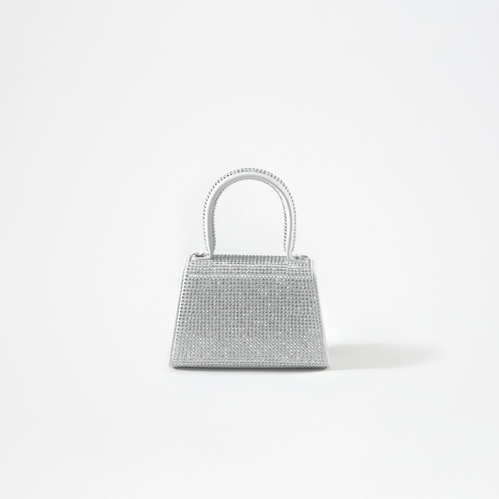 A woman wearing the Silver Rhinestone Bow Micro Bag