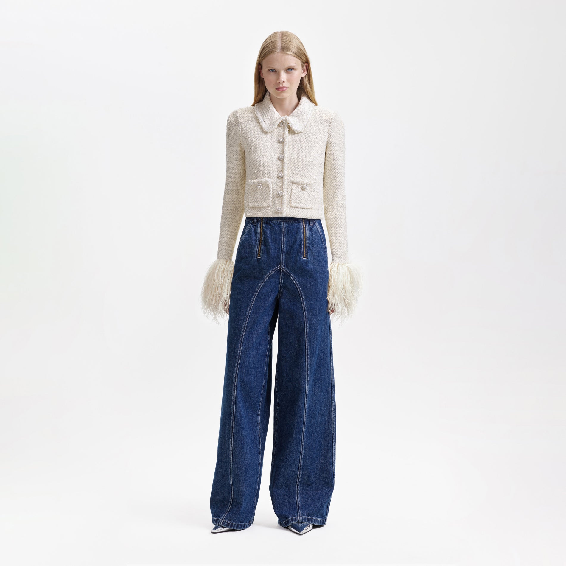 A woman wearing the Cream Sequin Pearl Cropped Feather Cardigan