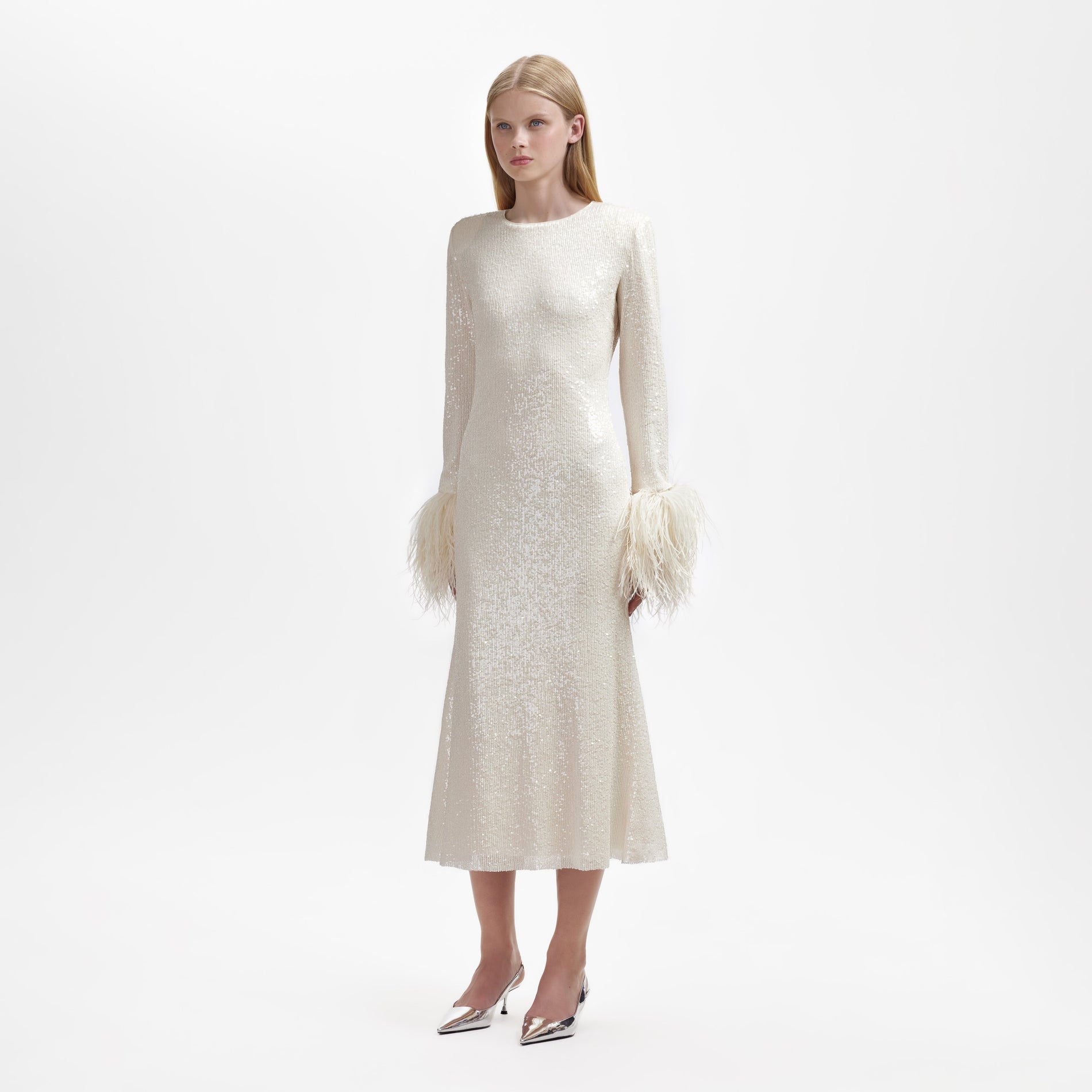 A woman wearing the Cream Sequin Feather Midi Dress