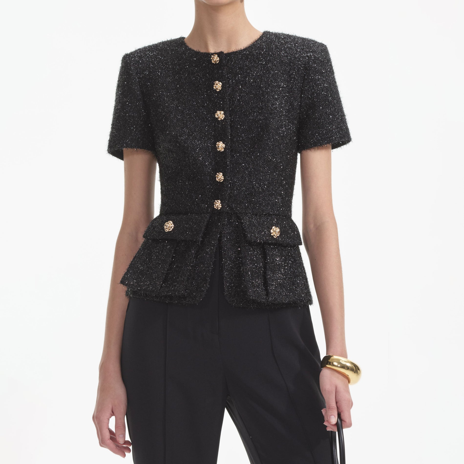 A close up of a woman wearing the Black Tinsel Boucle Jumpsuit