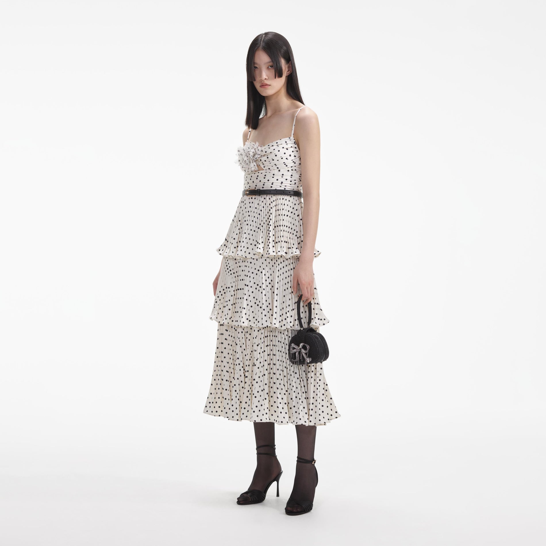 Side view of a woman wearing the Cream Polka Dot Tiered Midi Dress