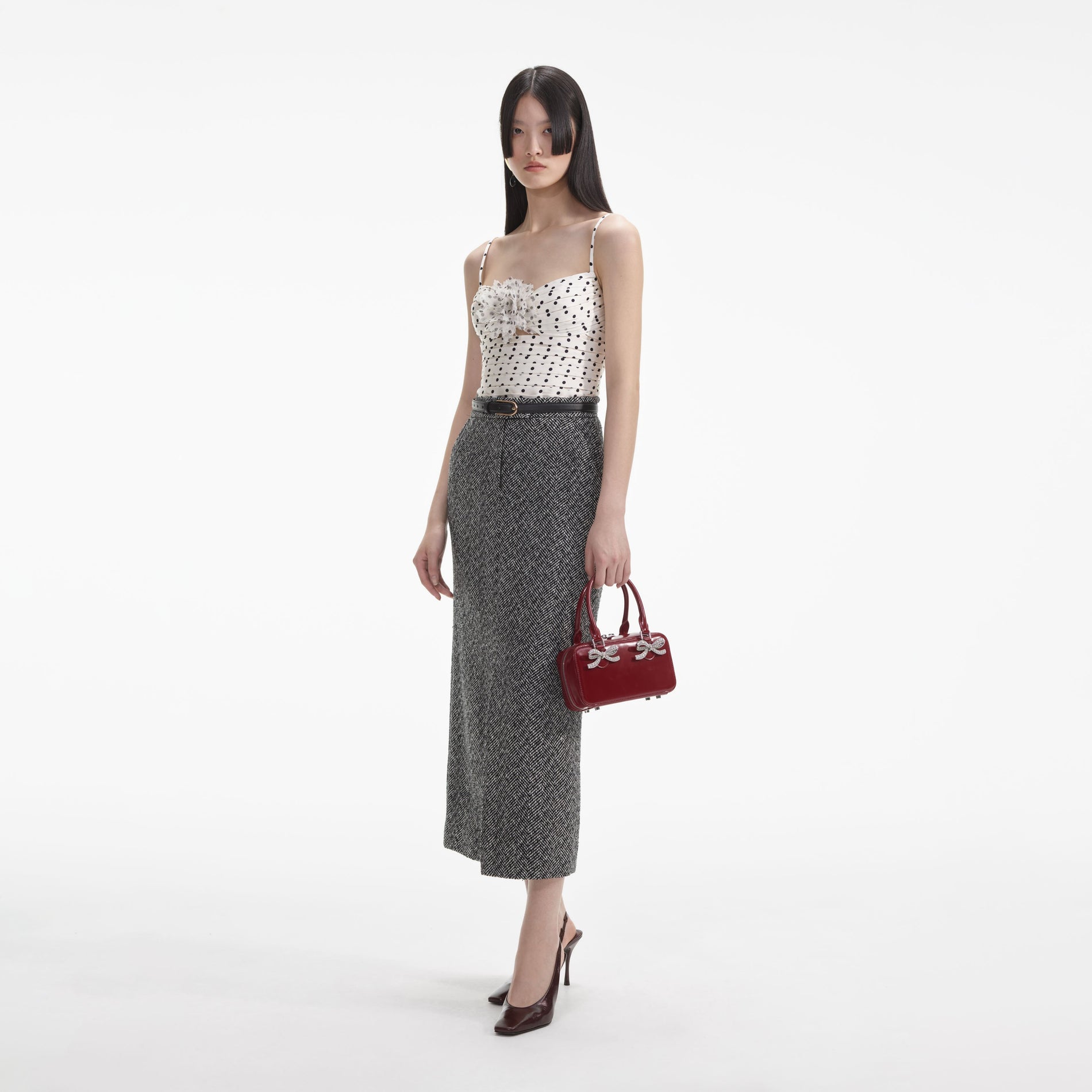 Side view of a woman wearing the Cream Polka Dot Satin Top