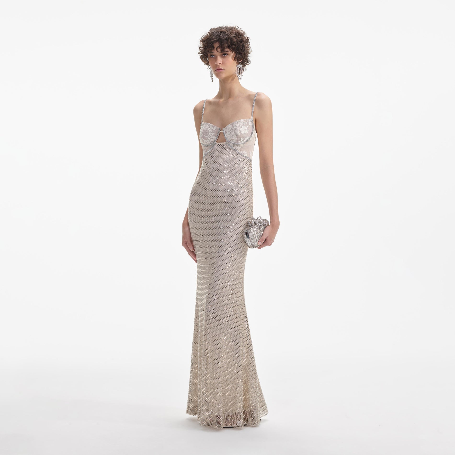 Side view of a woman wearing the Cream Rhinestone Mesh Maxi Dress