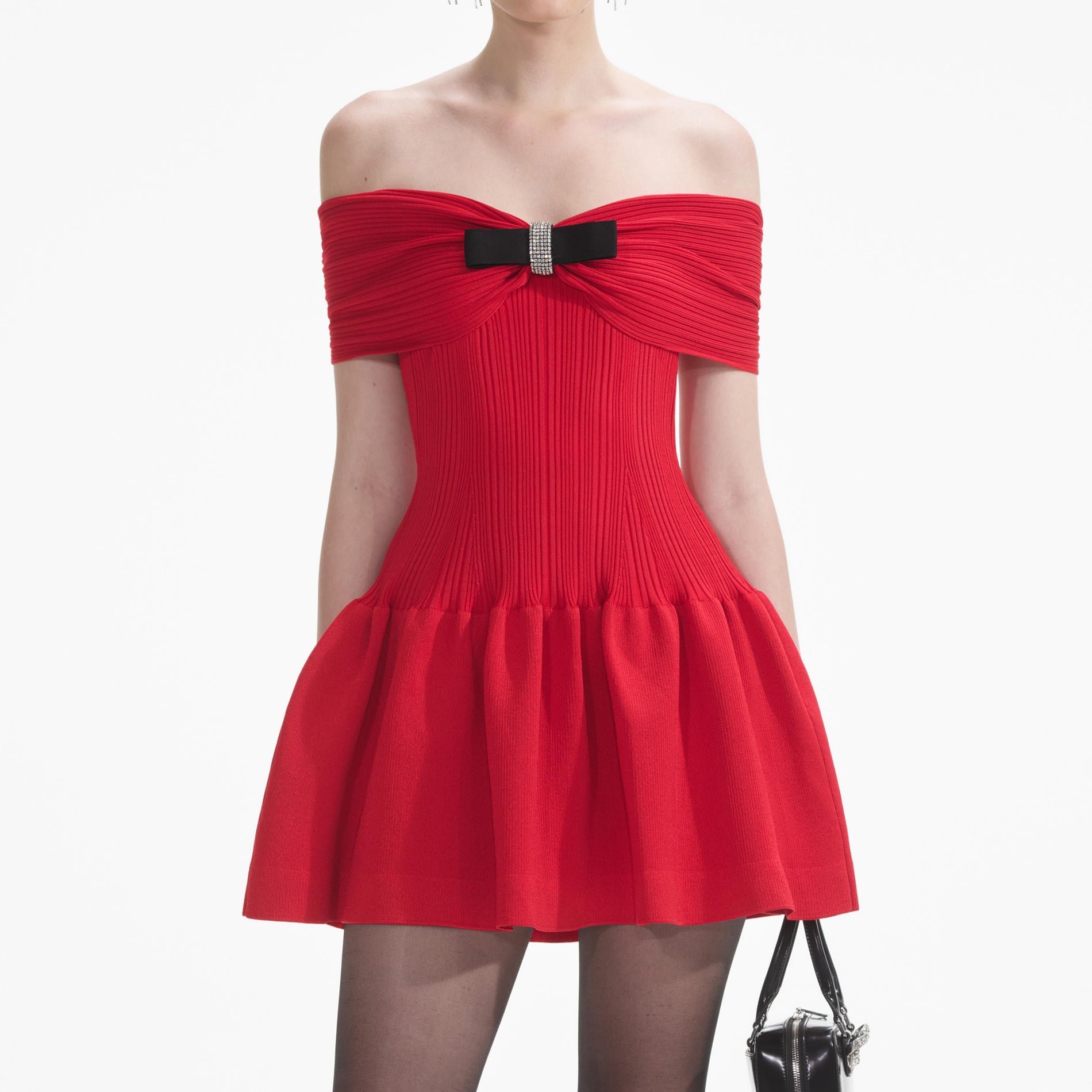 A close up of a woman wearing the Red Knit Bow Mini Dress