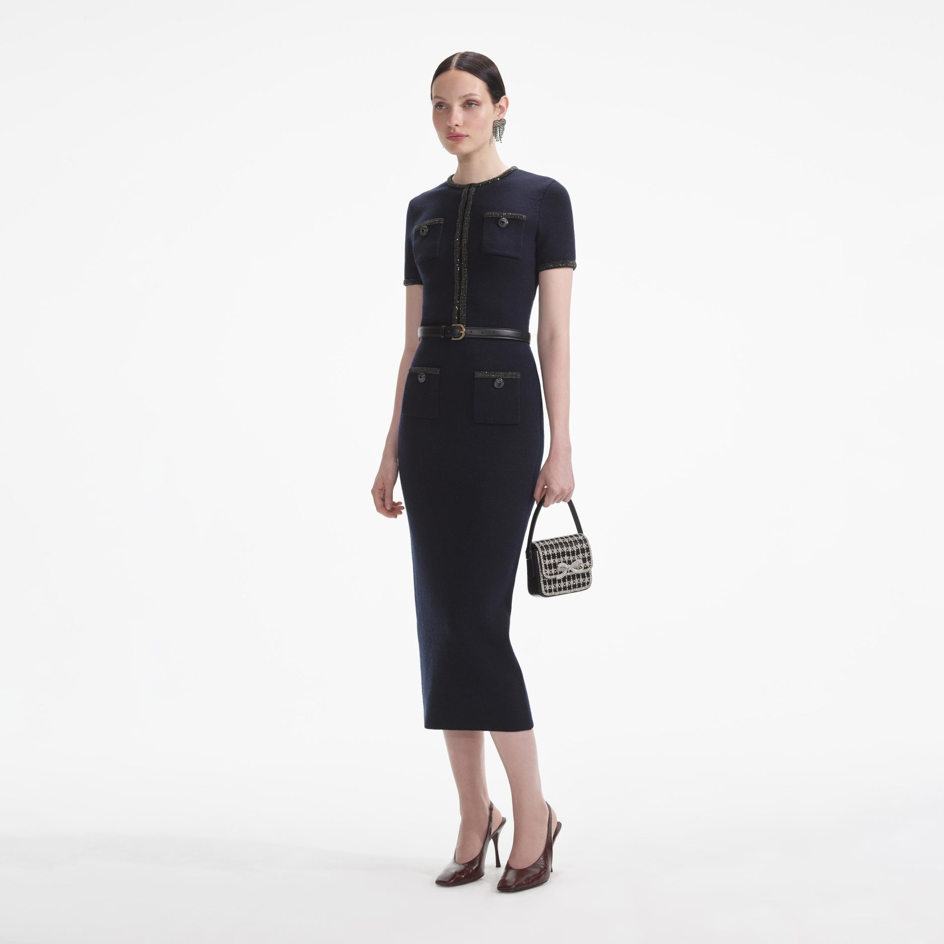 Side view of a woman wearing the Navy Embellished Knit Midi Skirt