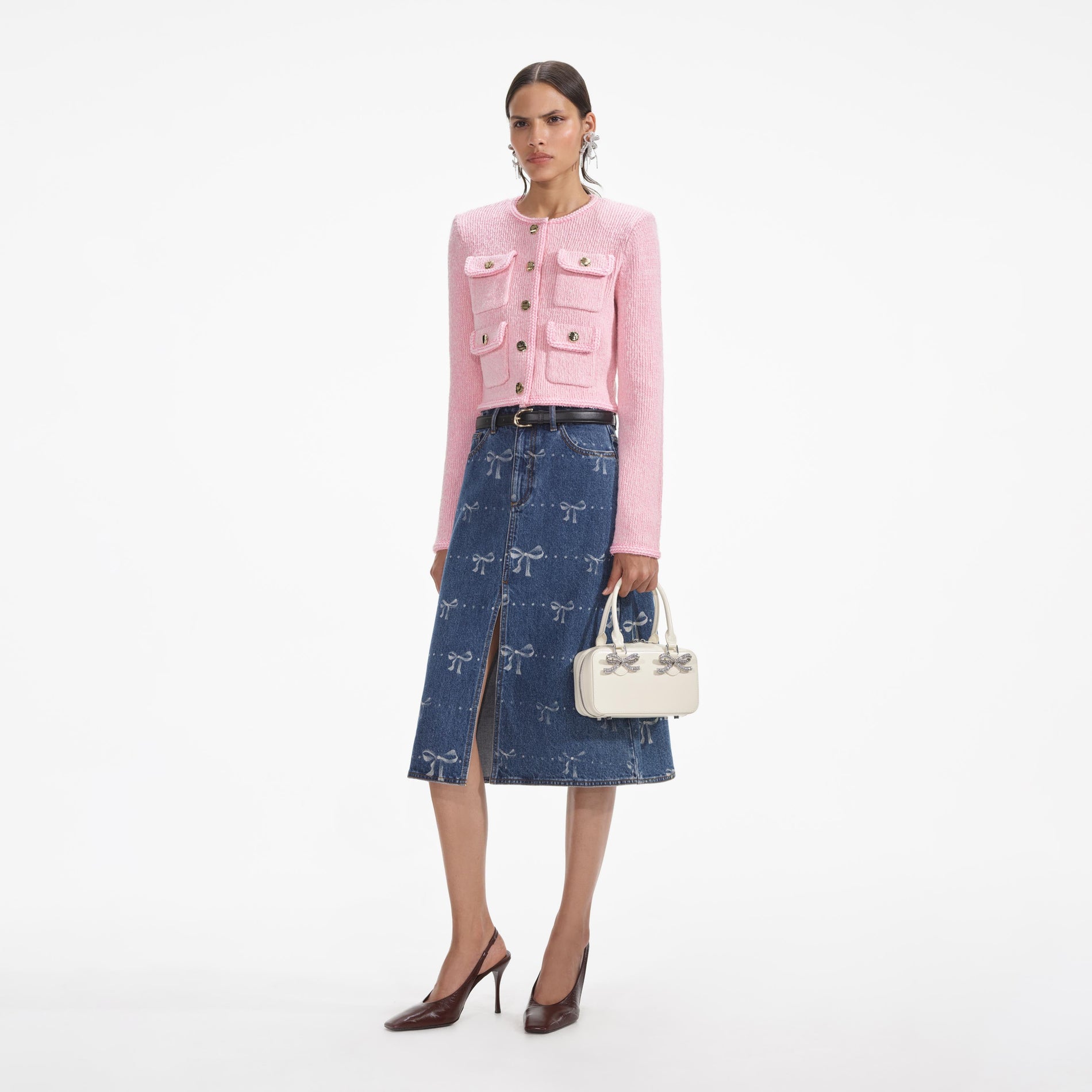 Side view of a woman wearing the Pink Melange Merino Cardigan
