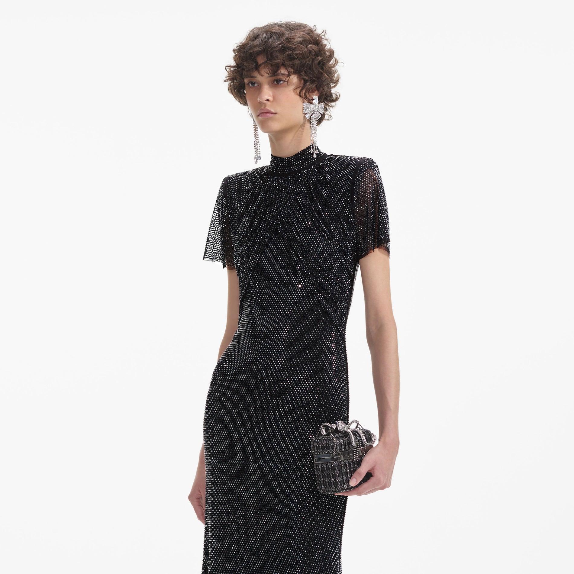 A close up of a woman wearing the Crystal Bow Droplet Earrings