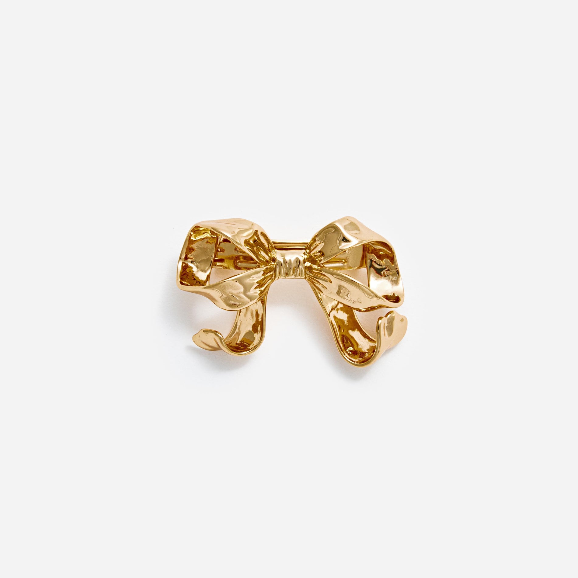 Front view of a woman wearing the Gold Bow Hair Clip