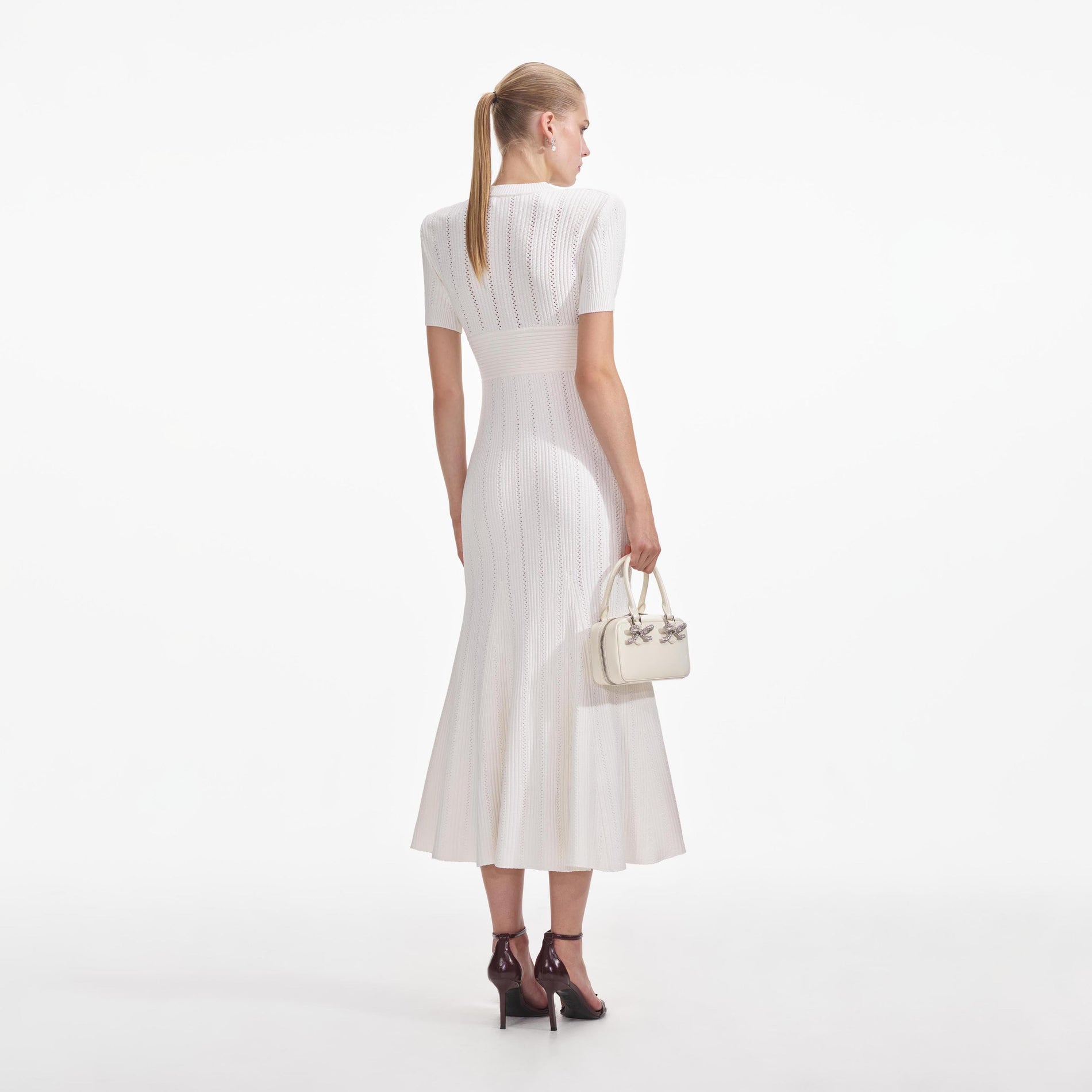 Back view of a woman wearing the Cream Pointelle Knit Midi Dress