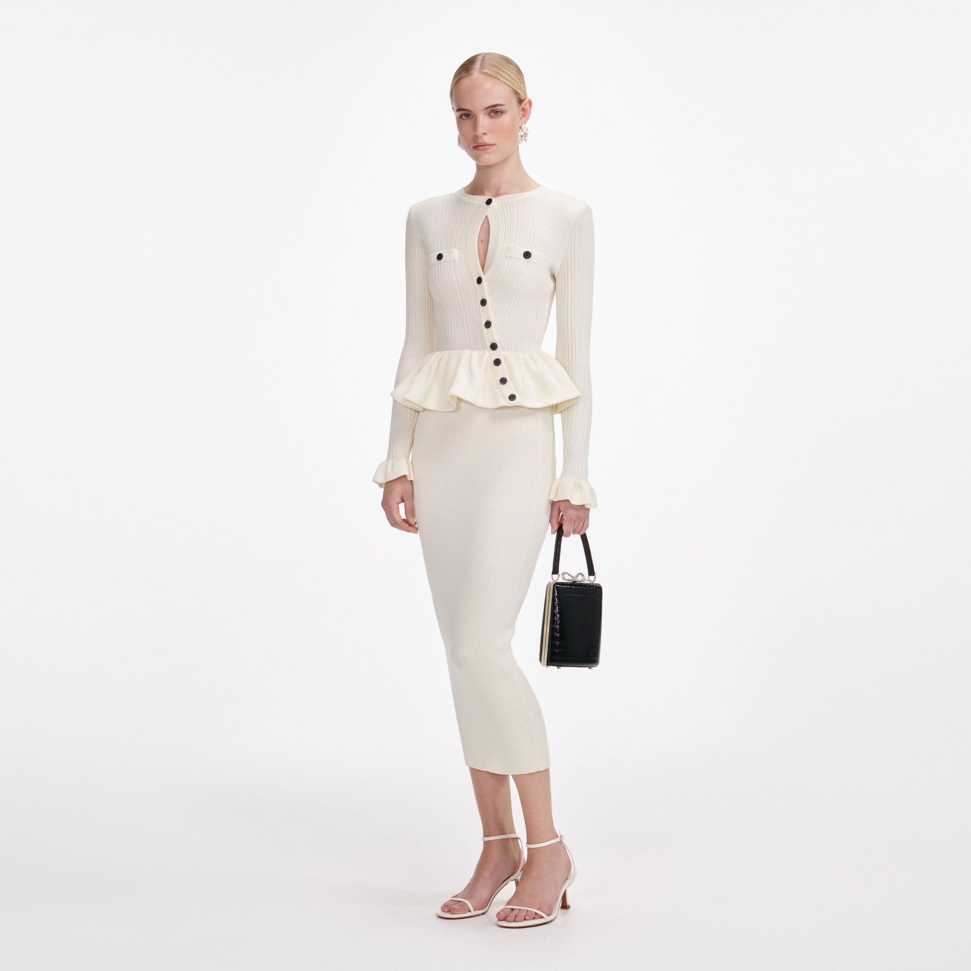 Side view of a woman wearing the Cream Asymmetric Knit Midi Dress