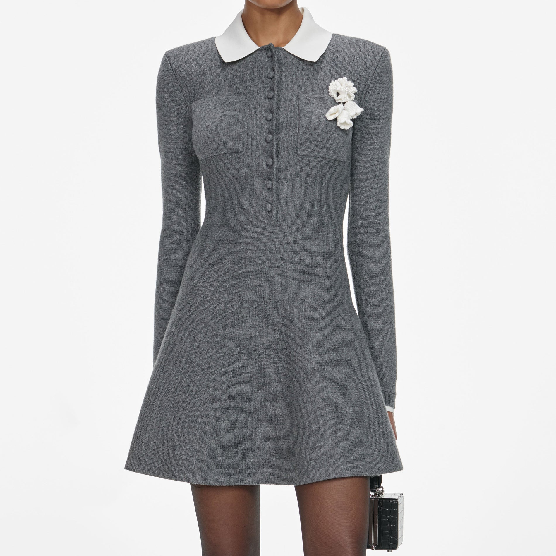 A close up of a woman wearing the Grey Crochet Flower Collared Knit Mini Dress