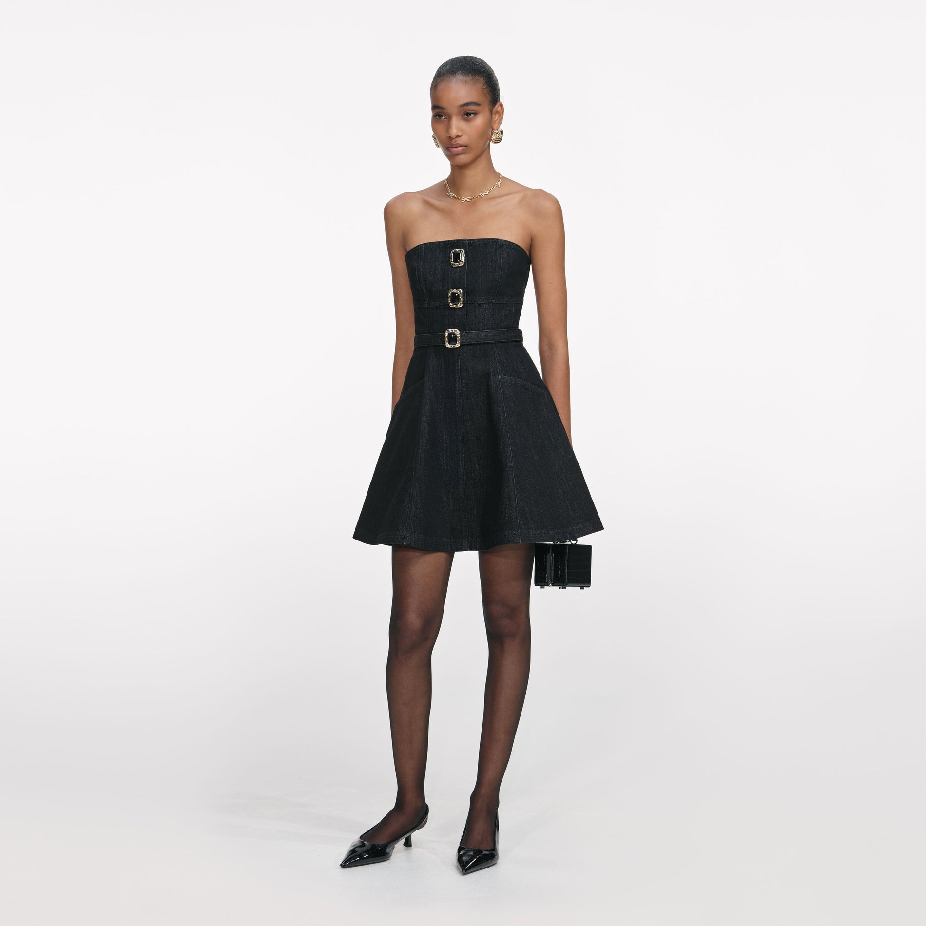 Side view of a woman wearing the Black Denim Bandeau Mini Dress