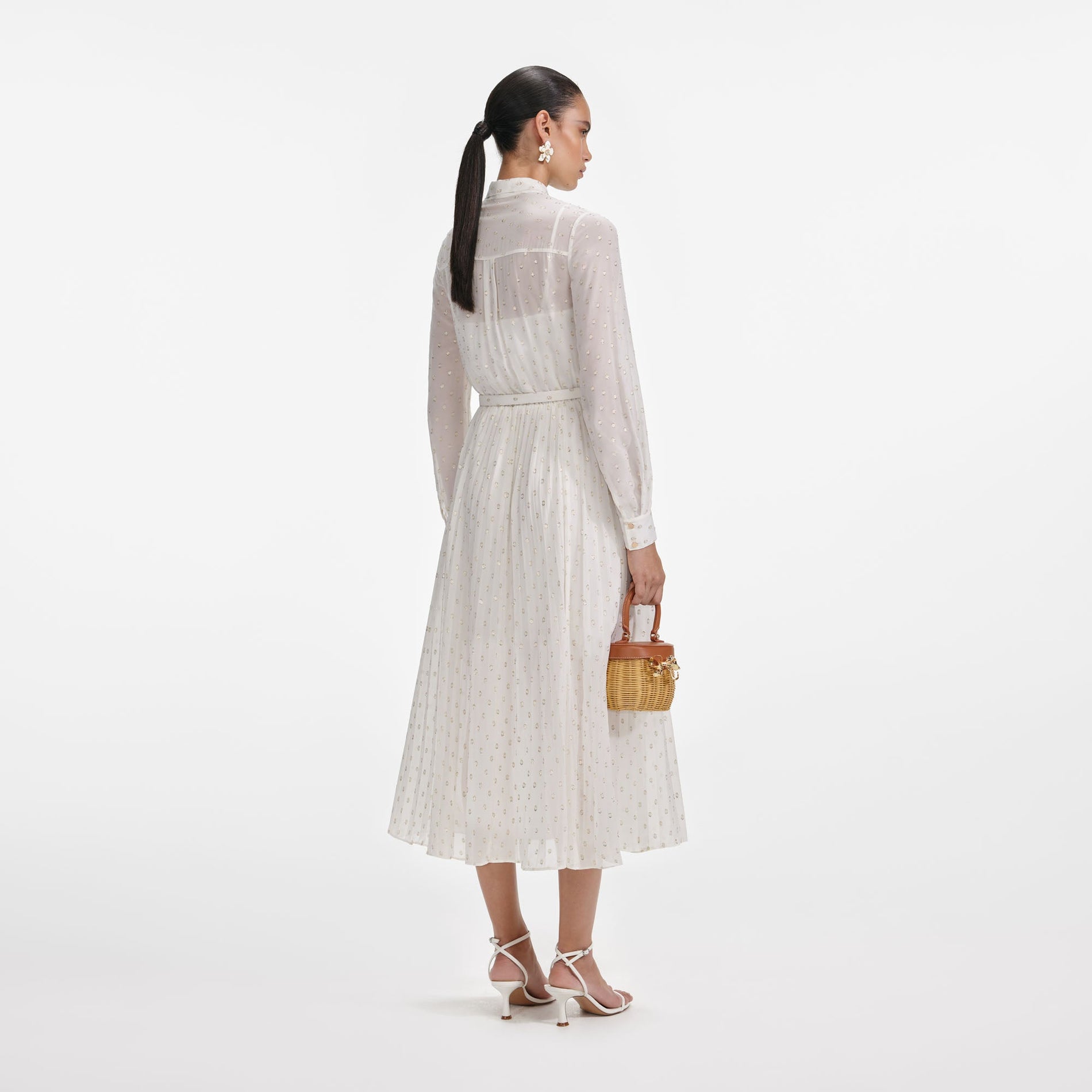 Back view of a woman wearing the Cream And Gold Pussy Bow Midi Dress