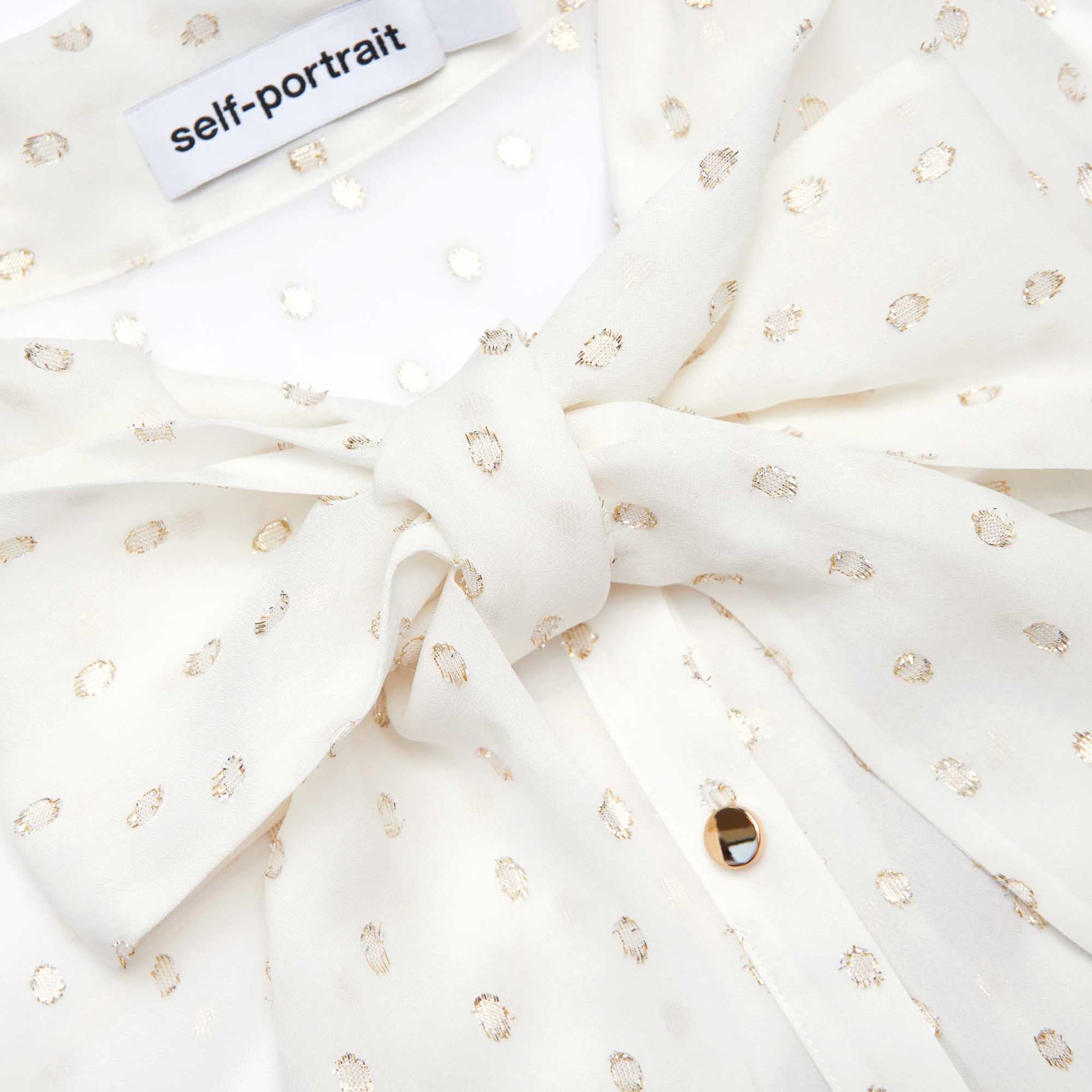 A close up of the fabric for the Cream And Gold Chiffon Blouse