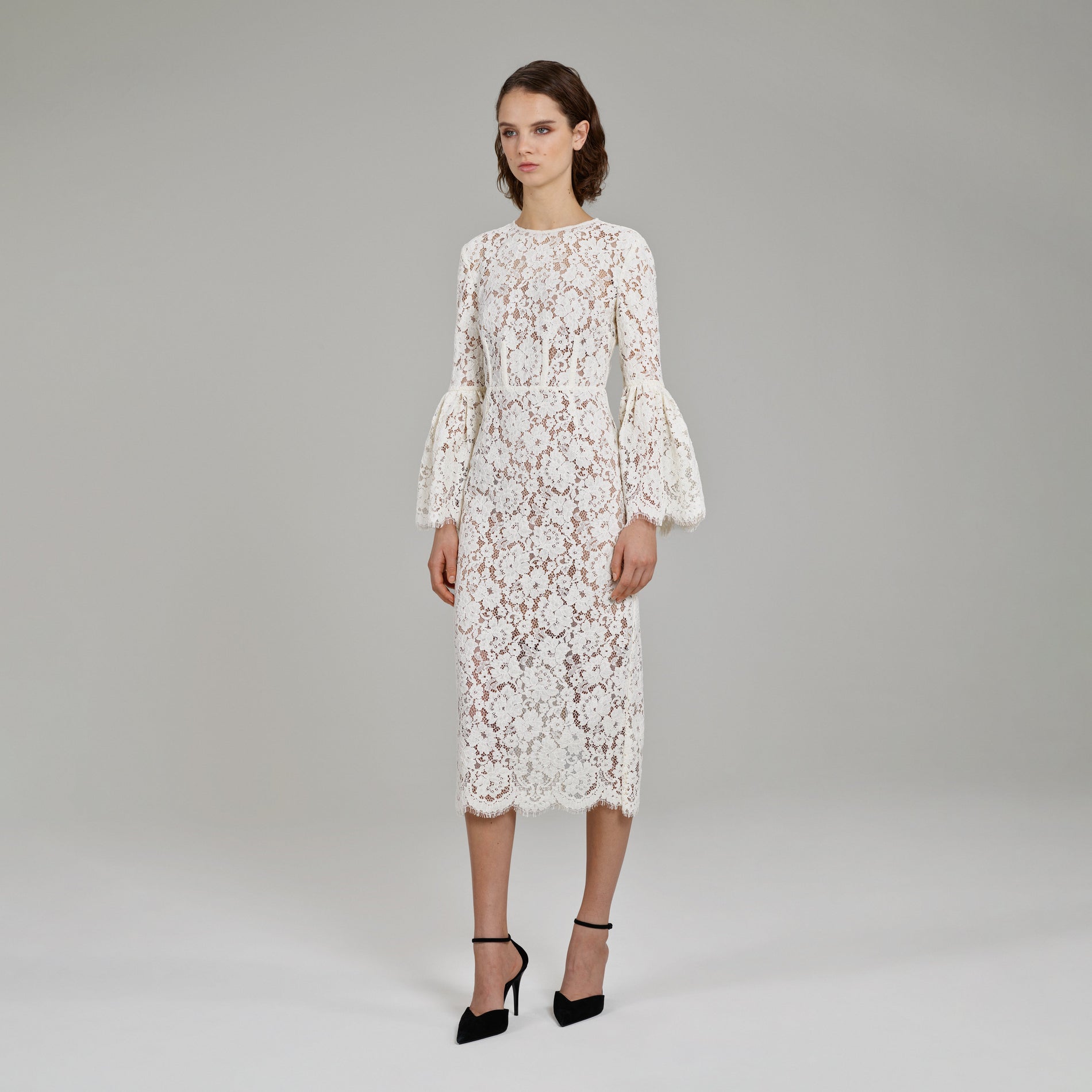 A woman wearing the Ivory Cotton Lace Midi Dress