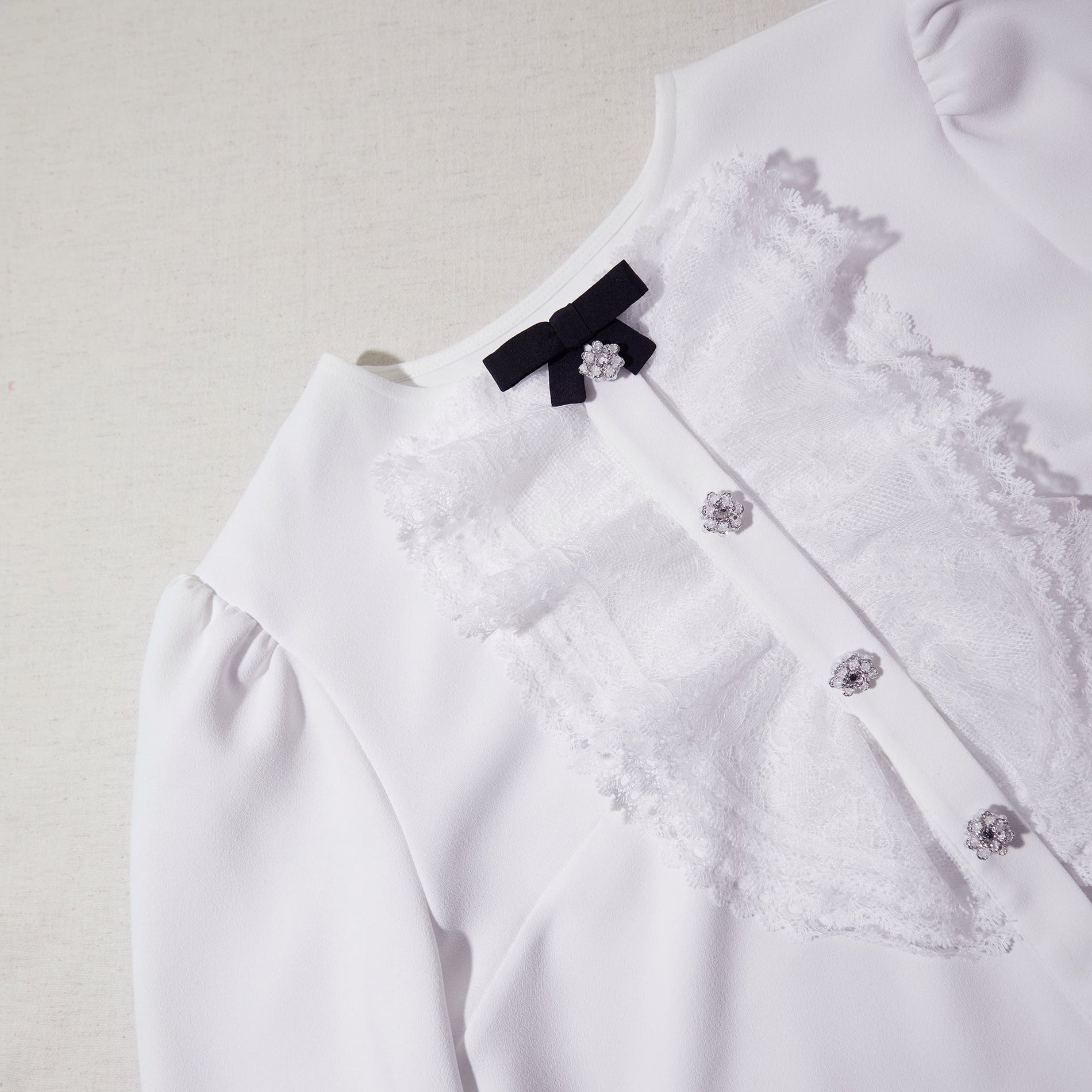 A close up of the fabric for the White Lace Bib Top