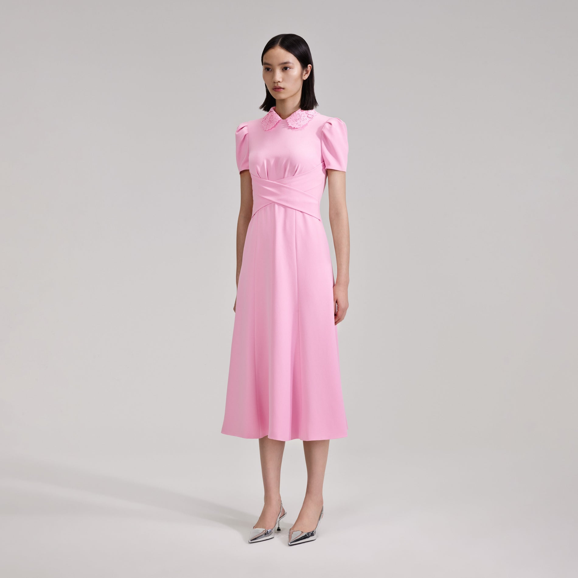 A woman wearing the Pink Heavy Crepe Midi Dress