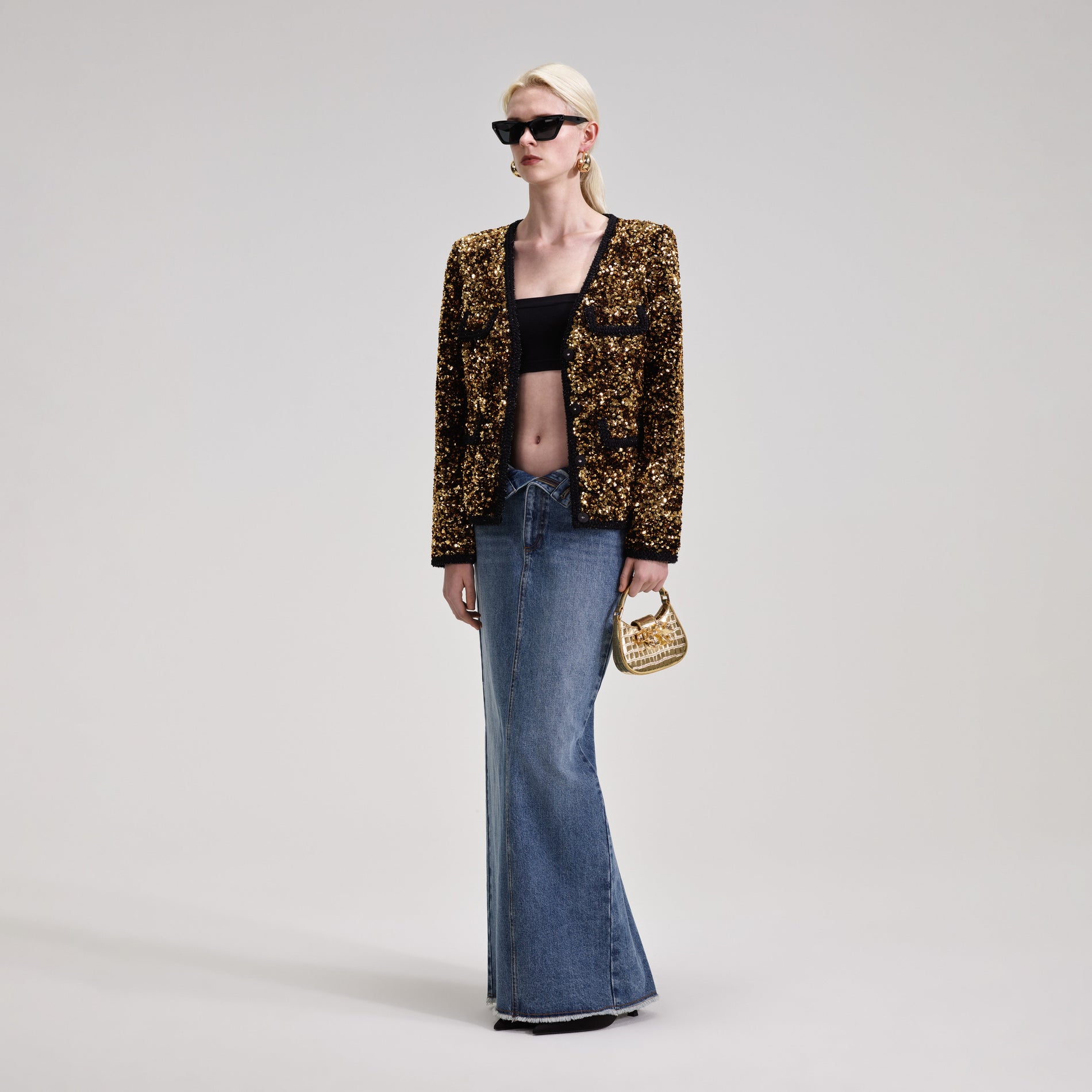 A woman wearing the Gold Sequin Jacket