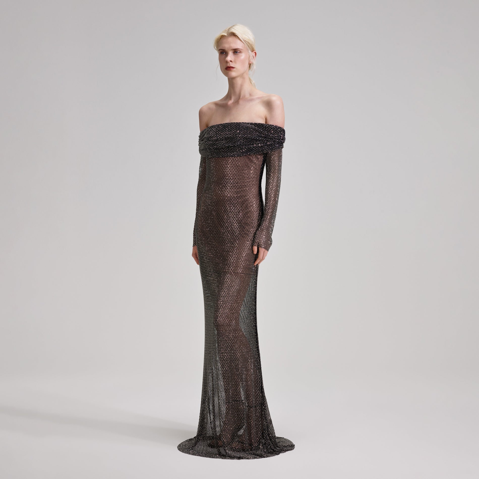 A woman wearing the Black Rhinestone Fishnet Maxi Dress