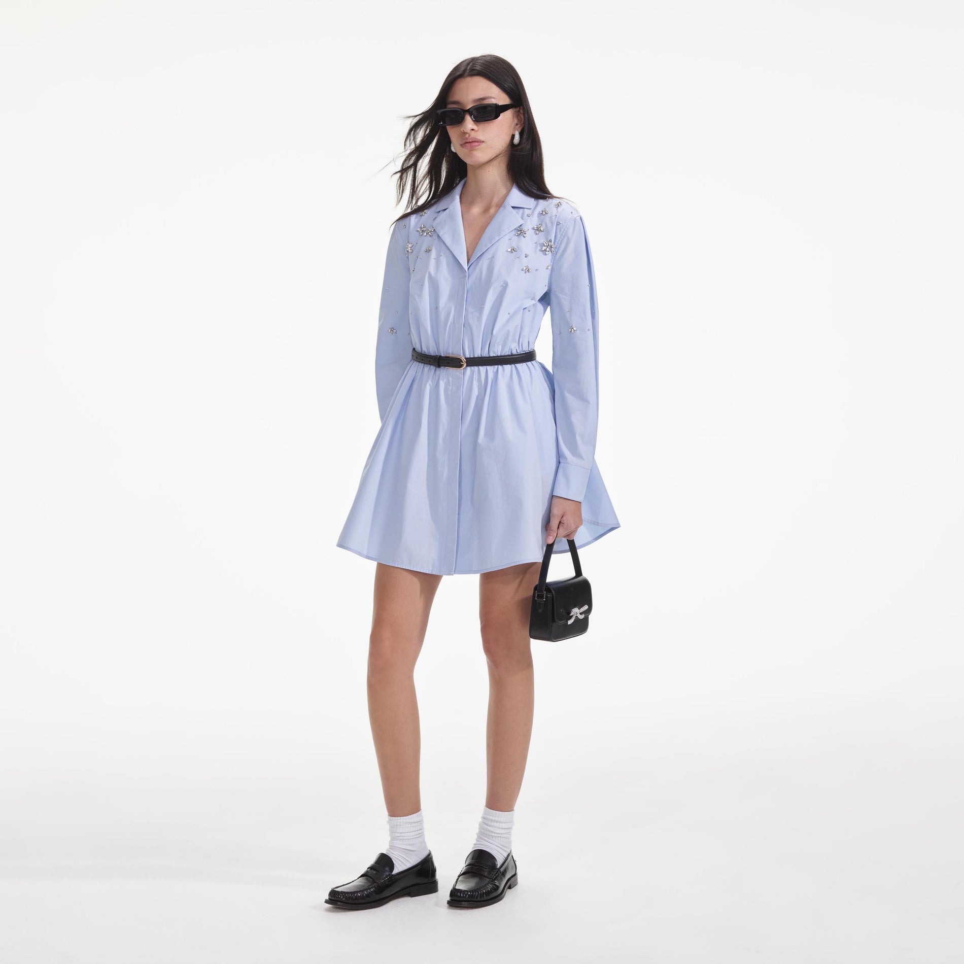 Side view of a woman wearing the Blue Cotton Embellished Mini Dress