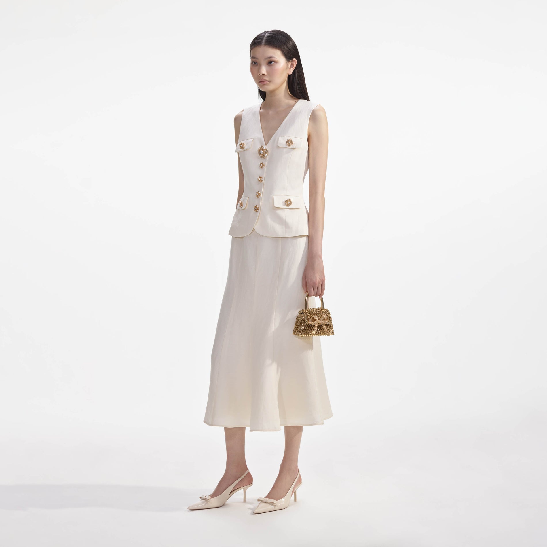 Side view of a woman wearing the Cream Linen Midi Dress