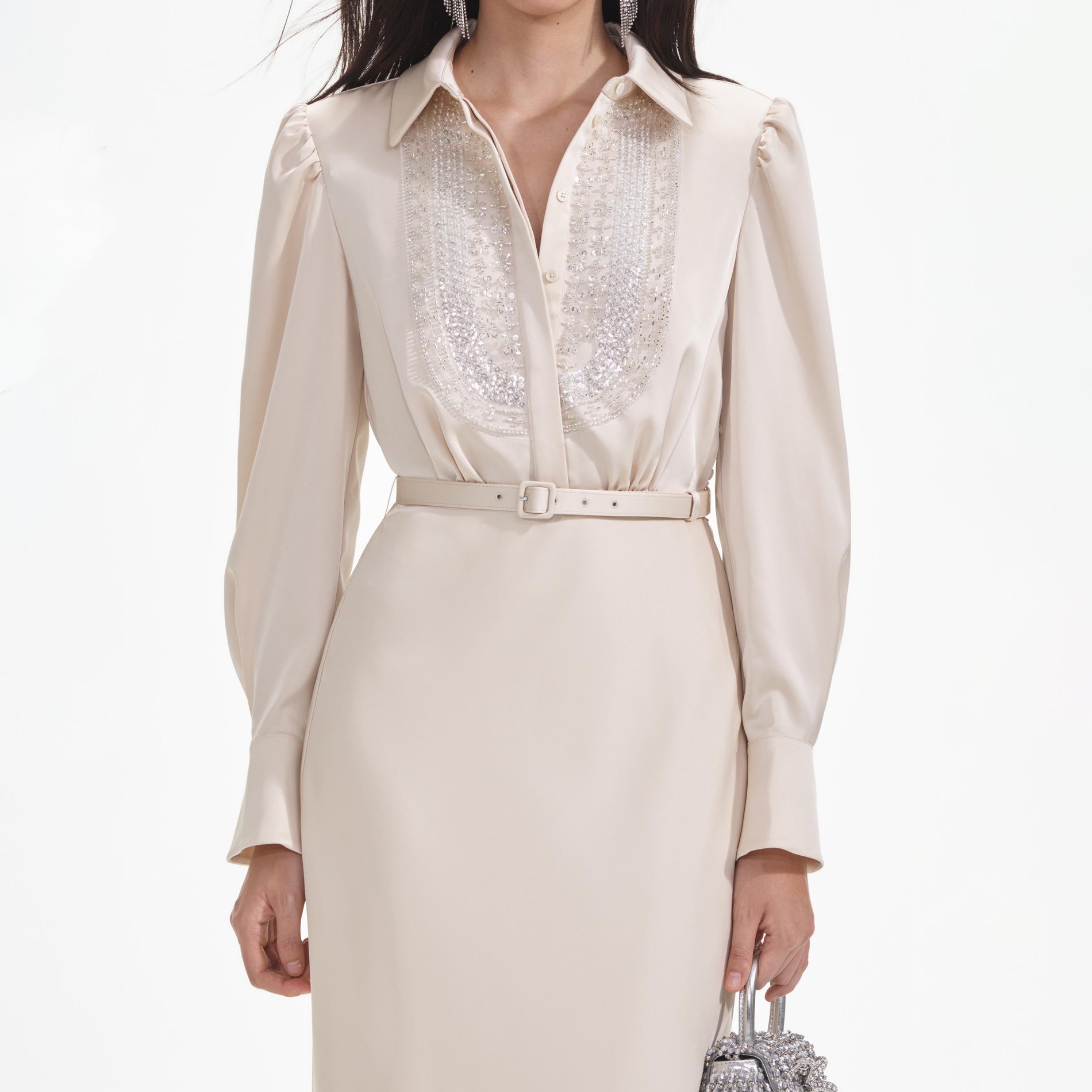 A close up of a woman wearing the Cream Satin Embellished Bib Maxi Dress