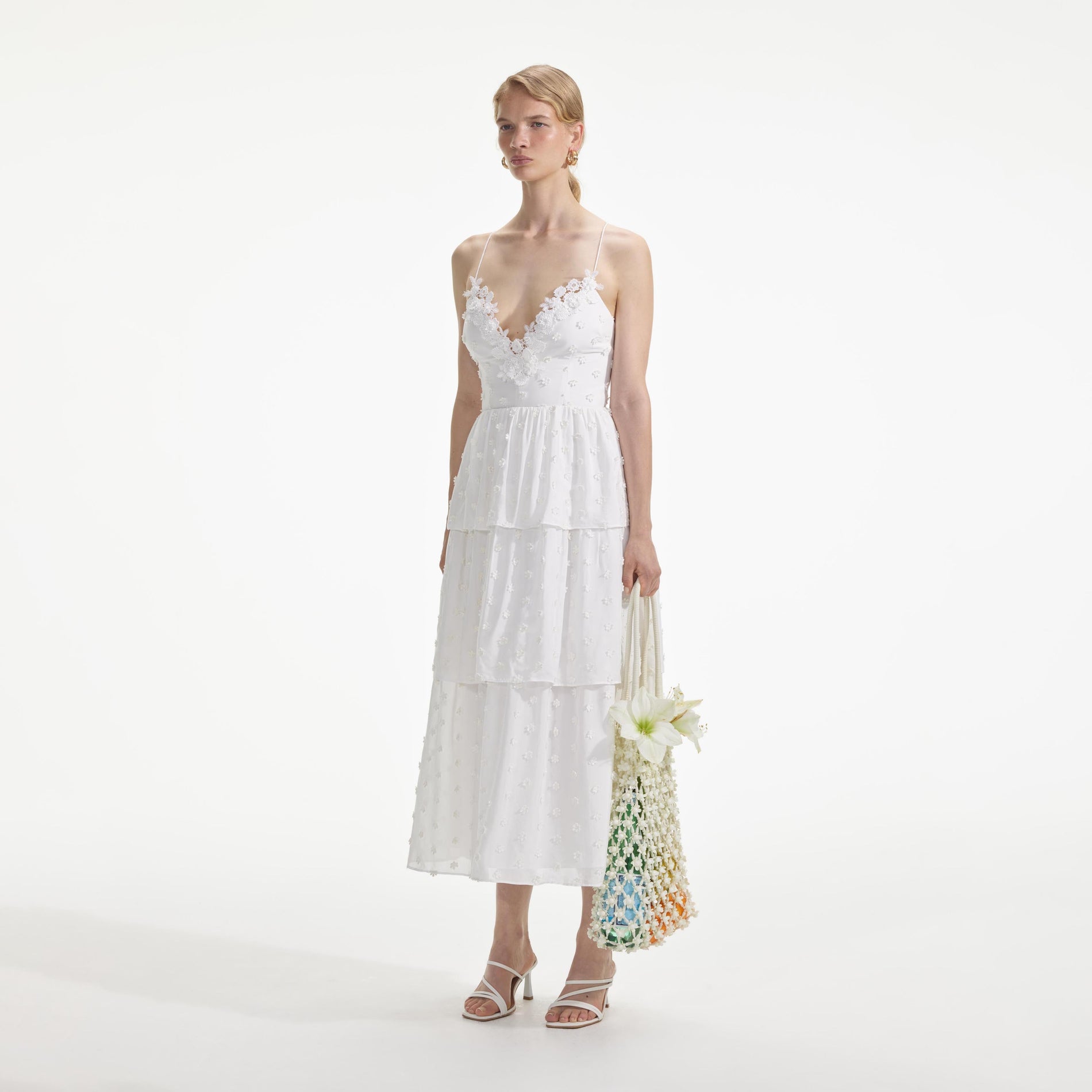 Side view of a woman wearing the White Tie Back Midi Dress