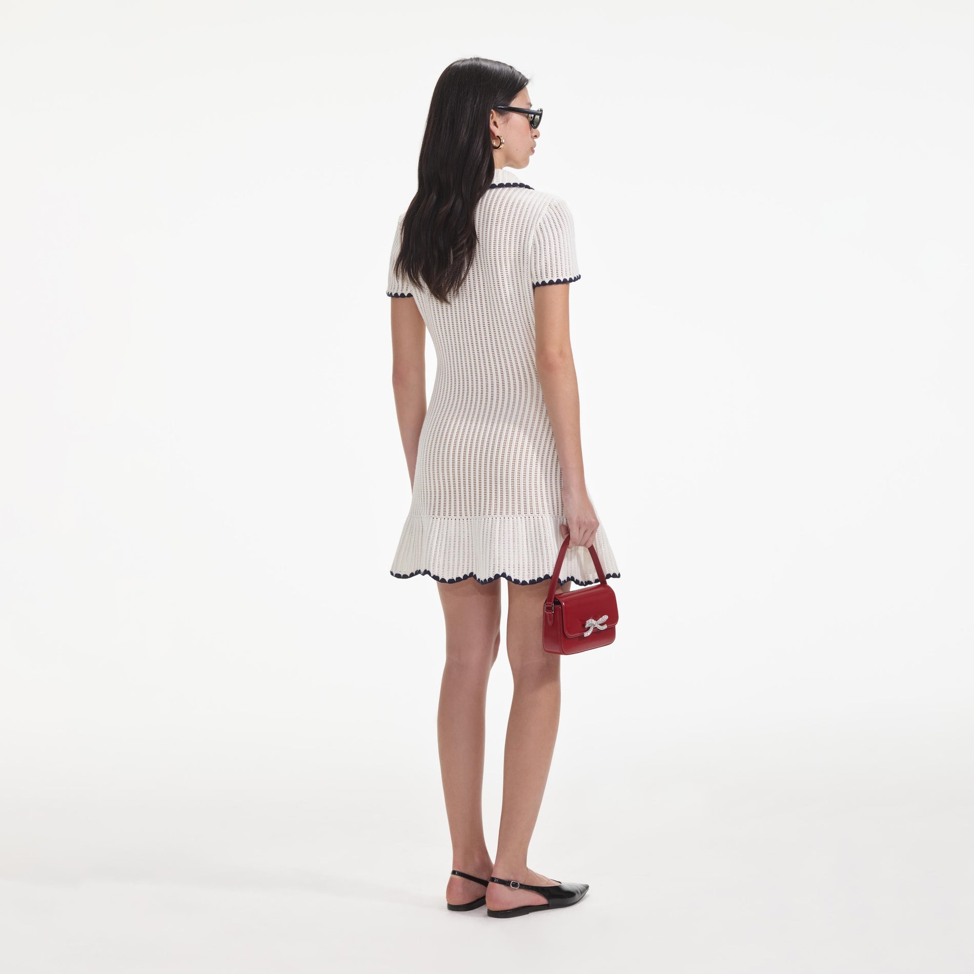 Back view of a woman wearing the Cream Crochet Collared Mini Dress