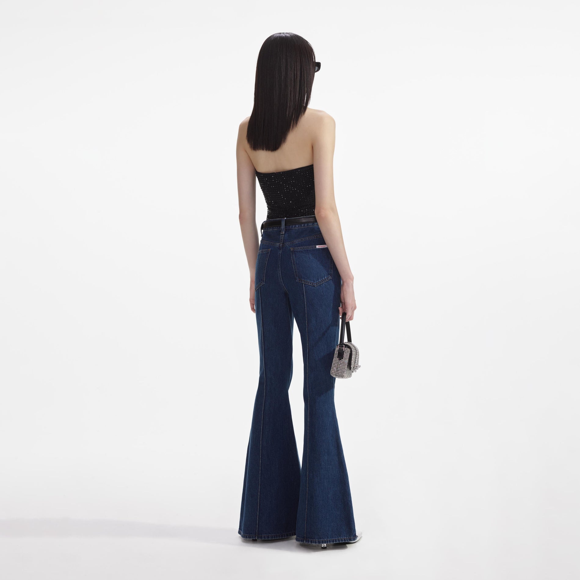 Back view of a woman wearing the Black Jersey Rhinestone Top