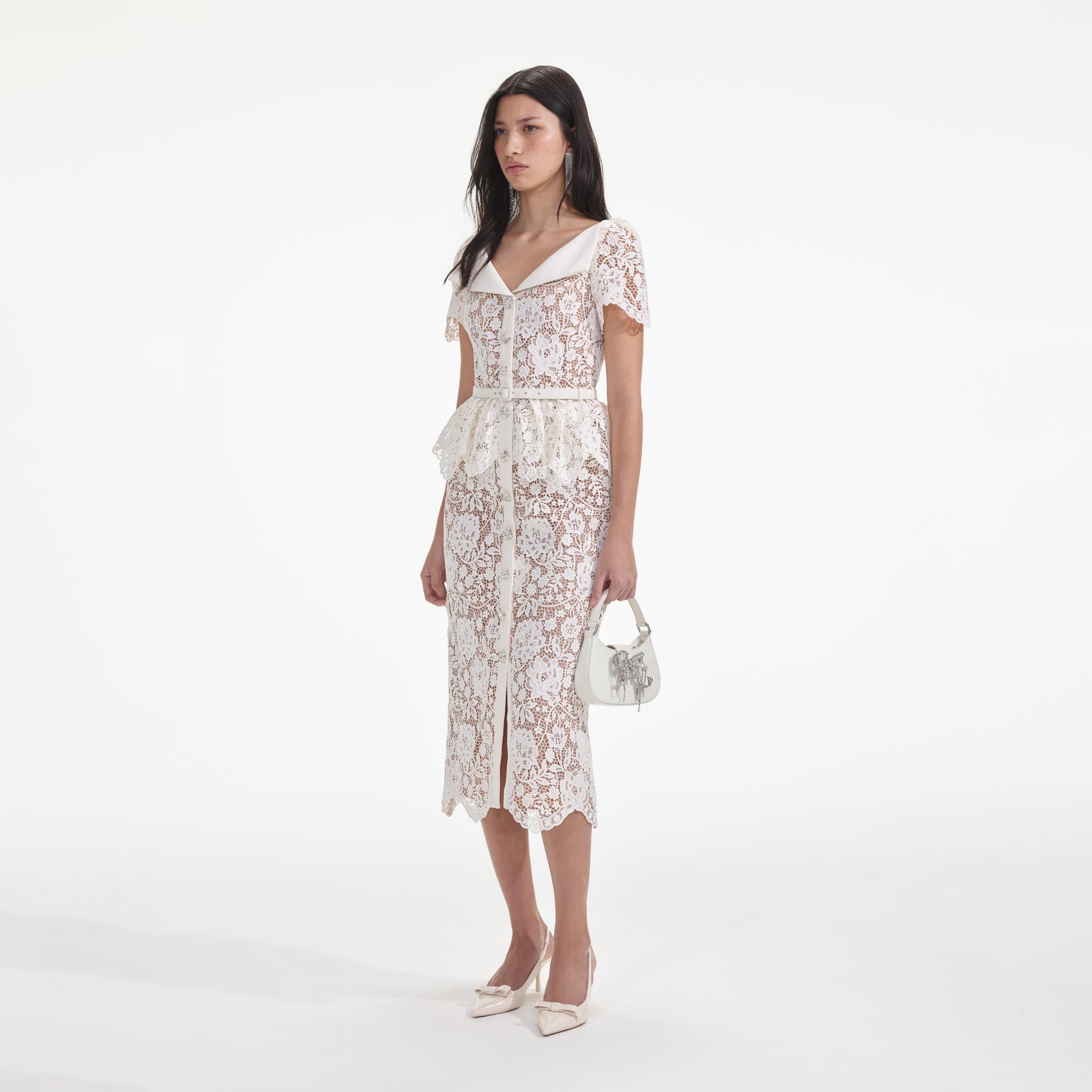 Side view of a woman wearing the Cream Lace Peplum Midi Dress