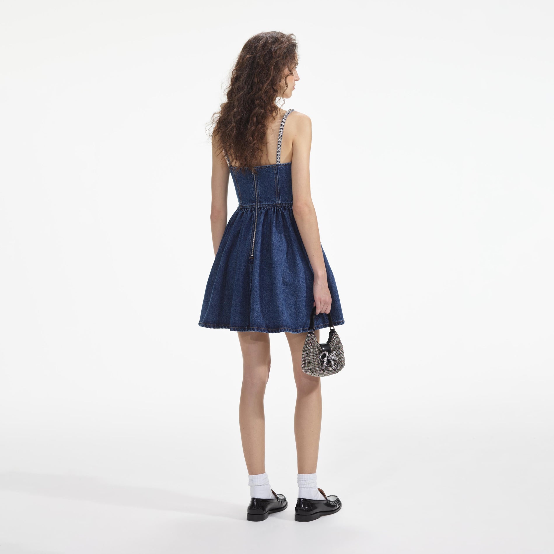 Side view of a woman wearing the Diamante Denim Flared Mini Dress