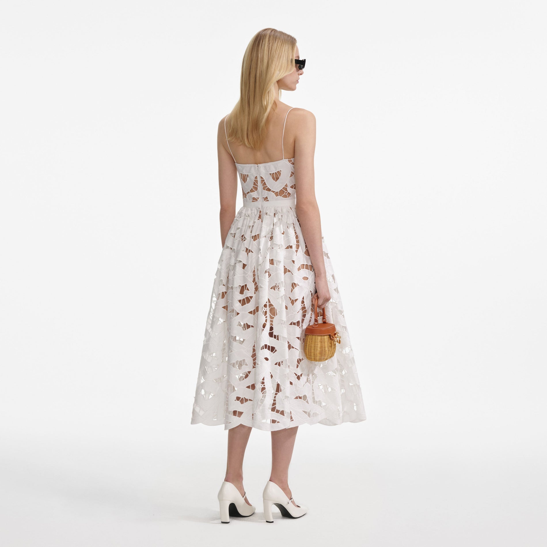Back view of a woman wearing the White Bow Embroidered Midi Dress