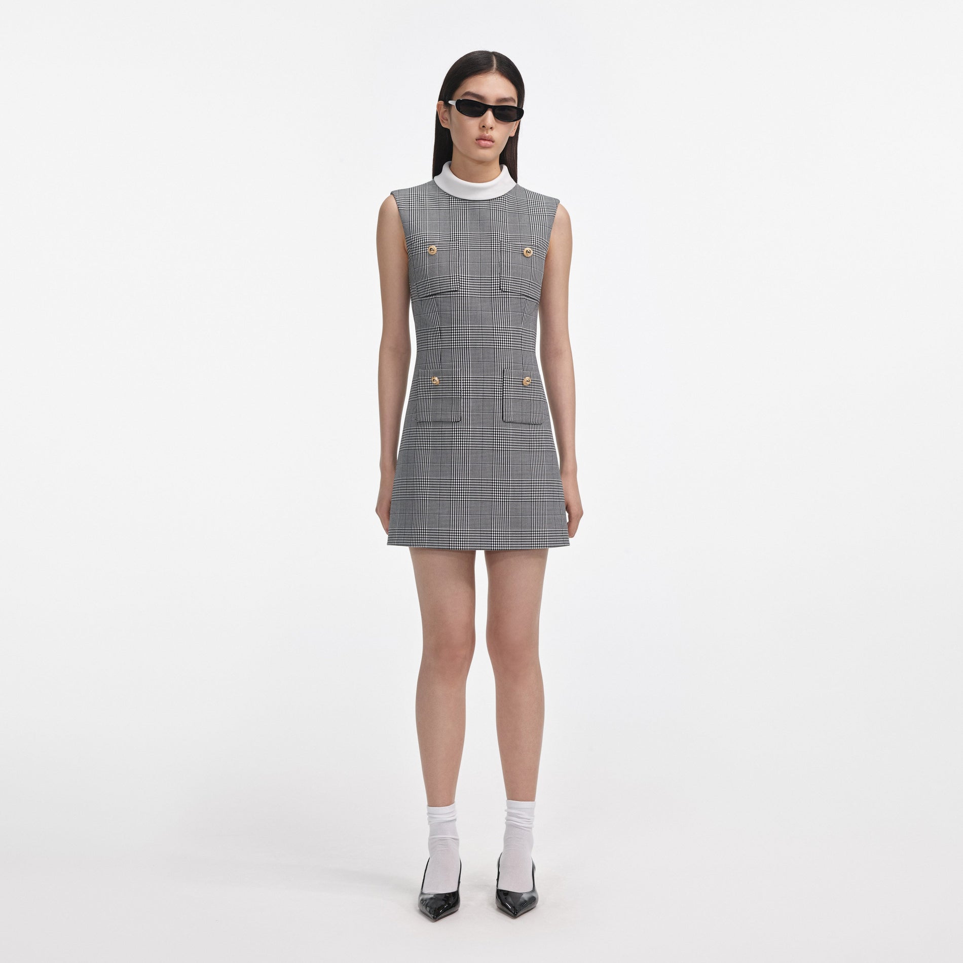 Front view of a woman wearing the Sleeveless Prince Of Wales Check Mini Dress