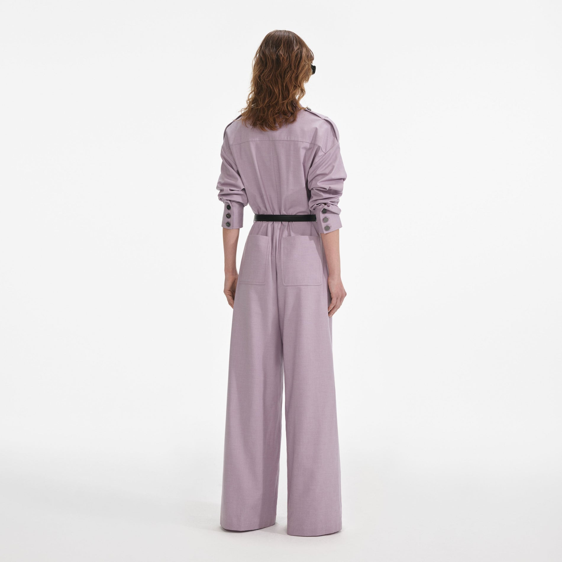 Back view of a woman wearing the Lilac Twill Jumpsuit