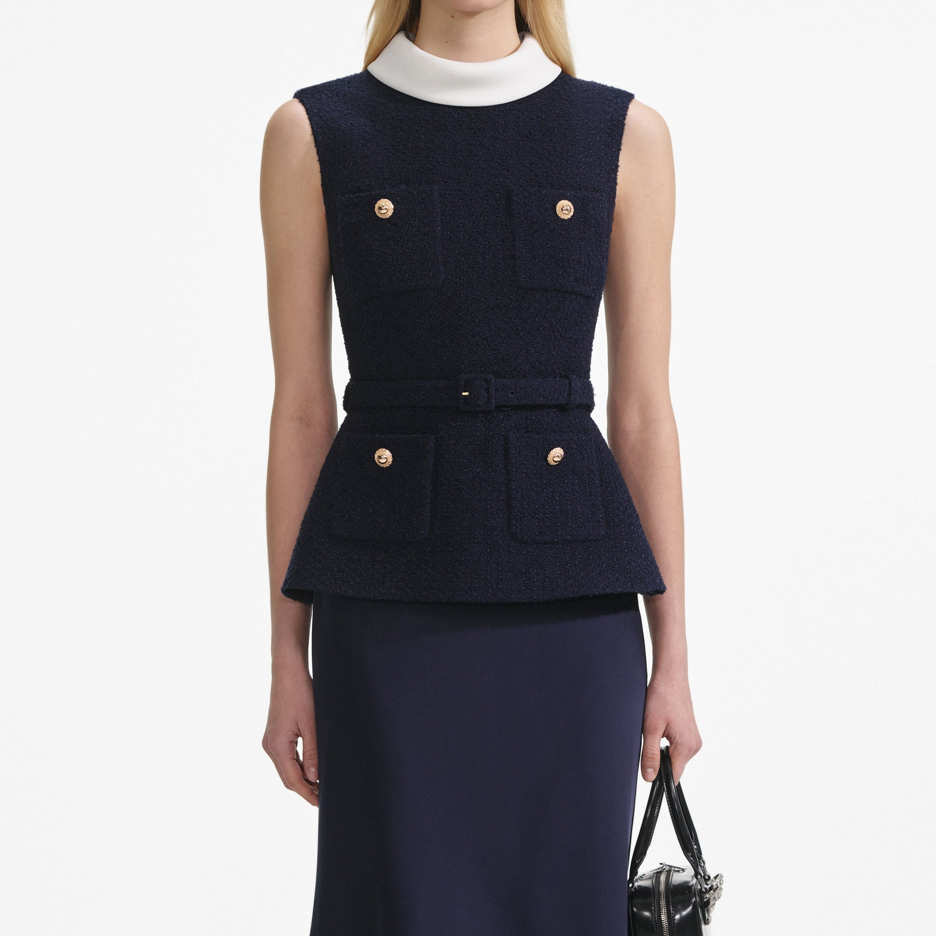 A close up of a woman wearing the Navy Boucle Sleeveless Midi Dress