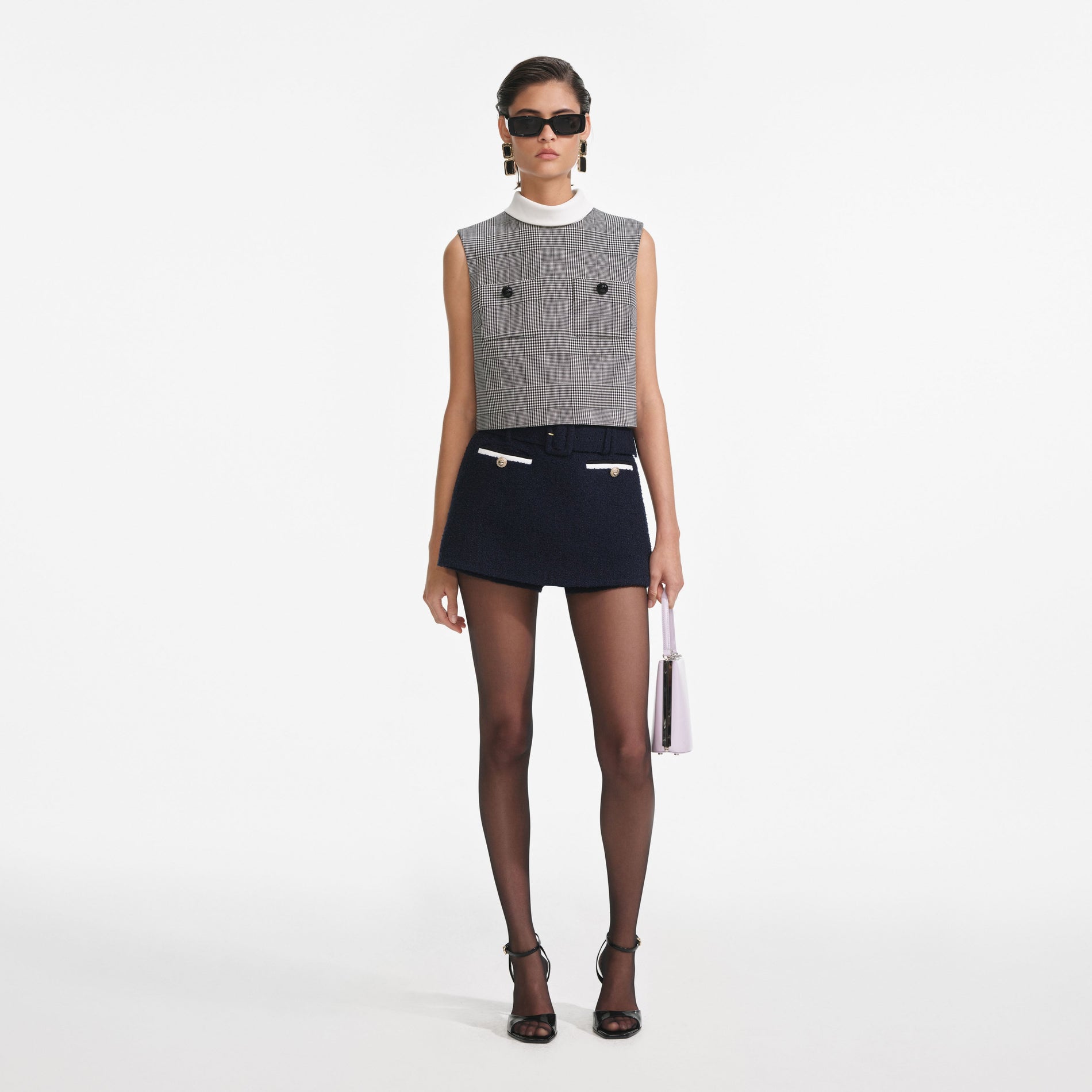 Front view of a woman wearing the Navy Boucle Skort