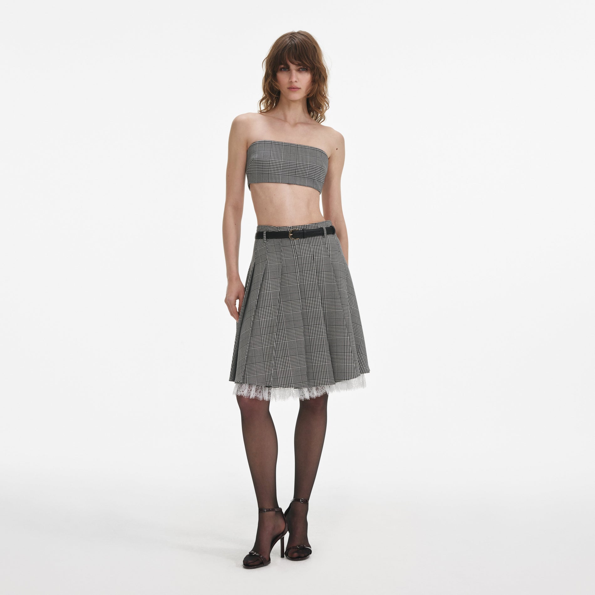 Front view of a woman wearing the Prince Of Wales Check Pleated Midi Skirt