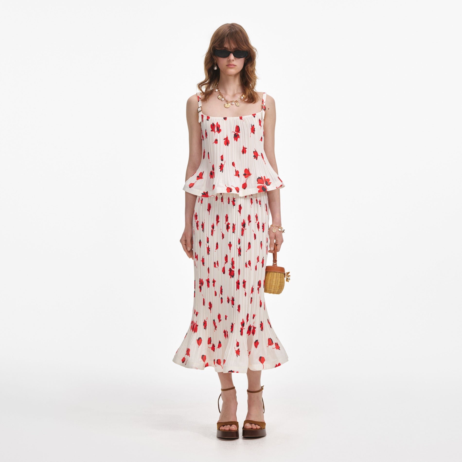 Front view of a woman wearing the White Floral Plisse Midi Skirt