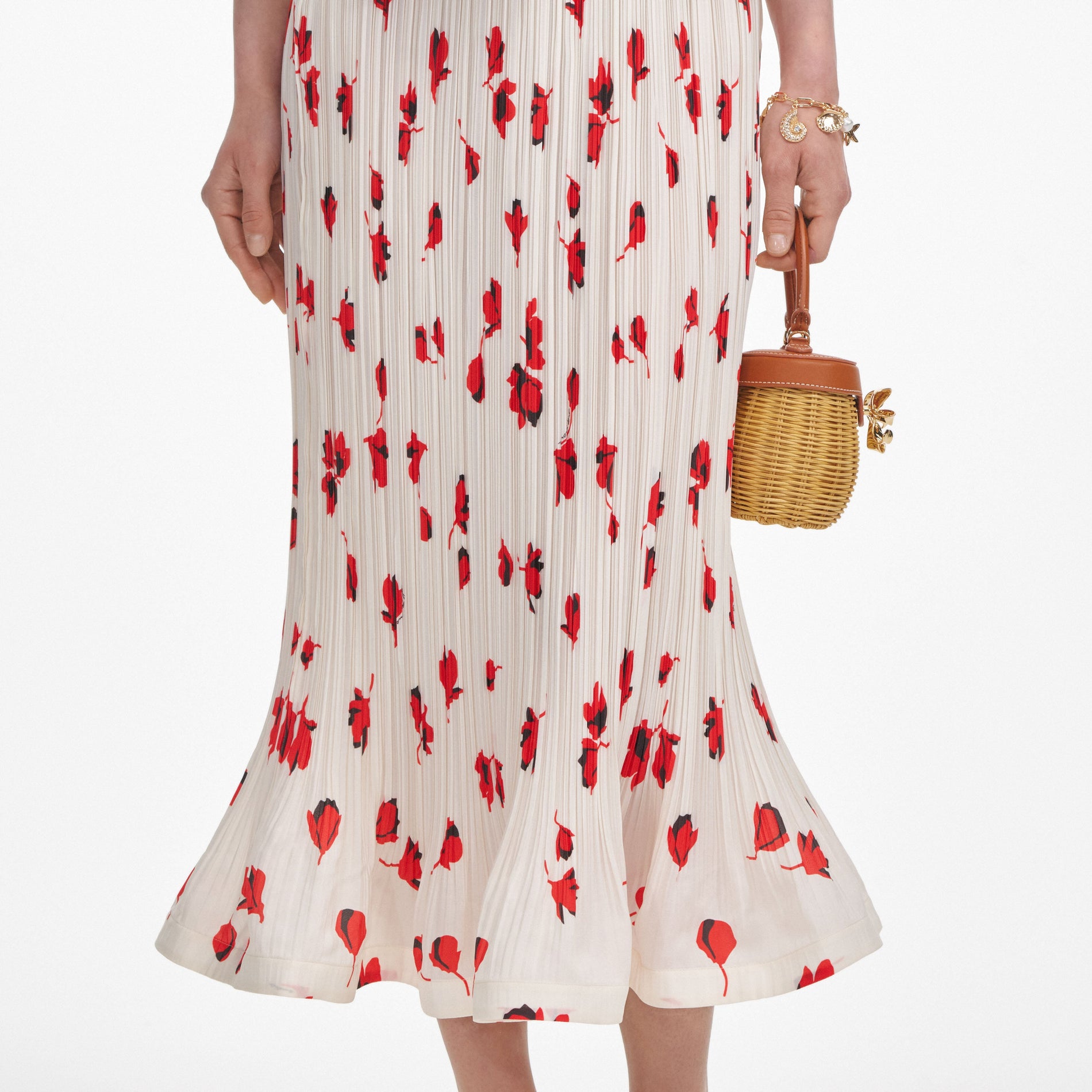 A close up of a woman wearing the White Floral Plisse Midi Skirt