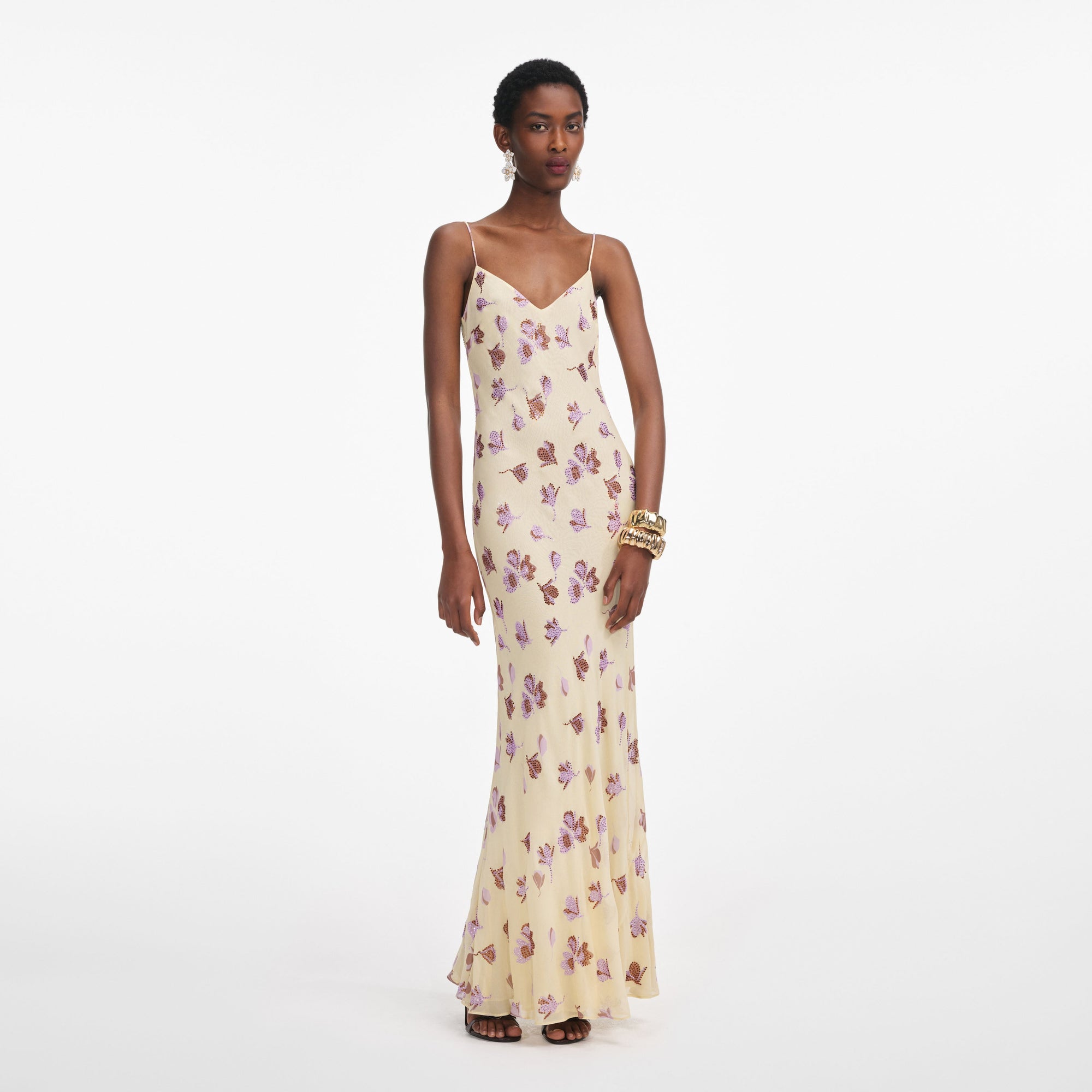 Front view of a woman wearing the Yellow Floral Rhinestone Maxi Dress