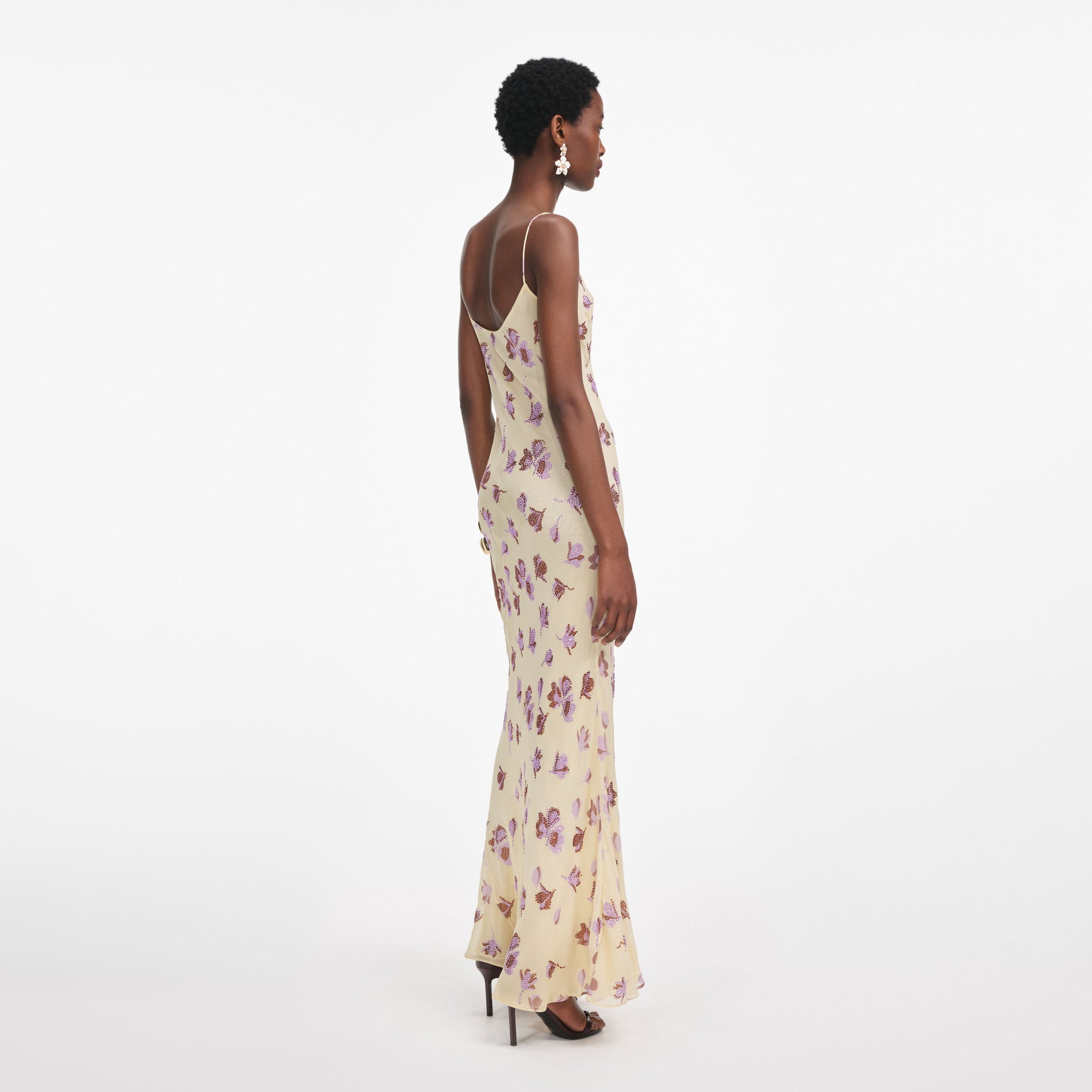 Back view of a woman wearing the Yellow Floral Rhinestone Maxi Dress