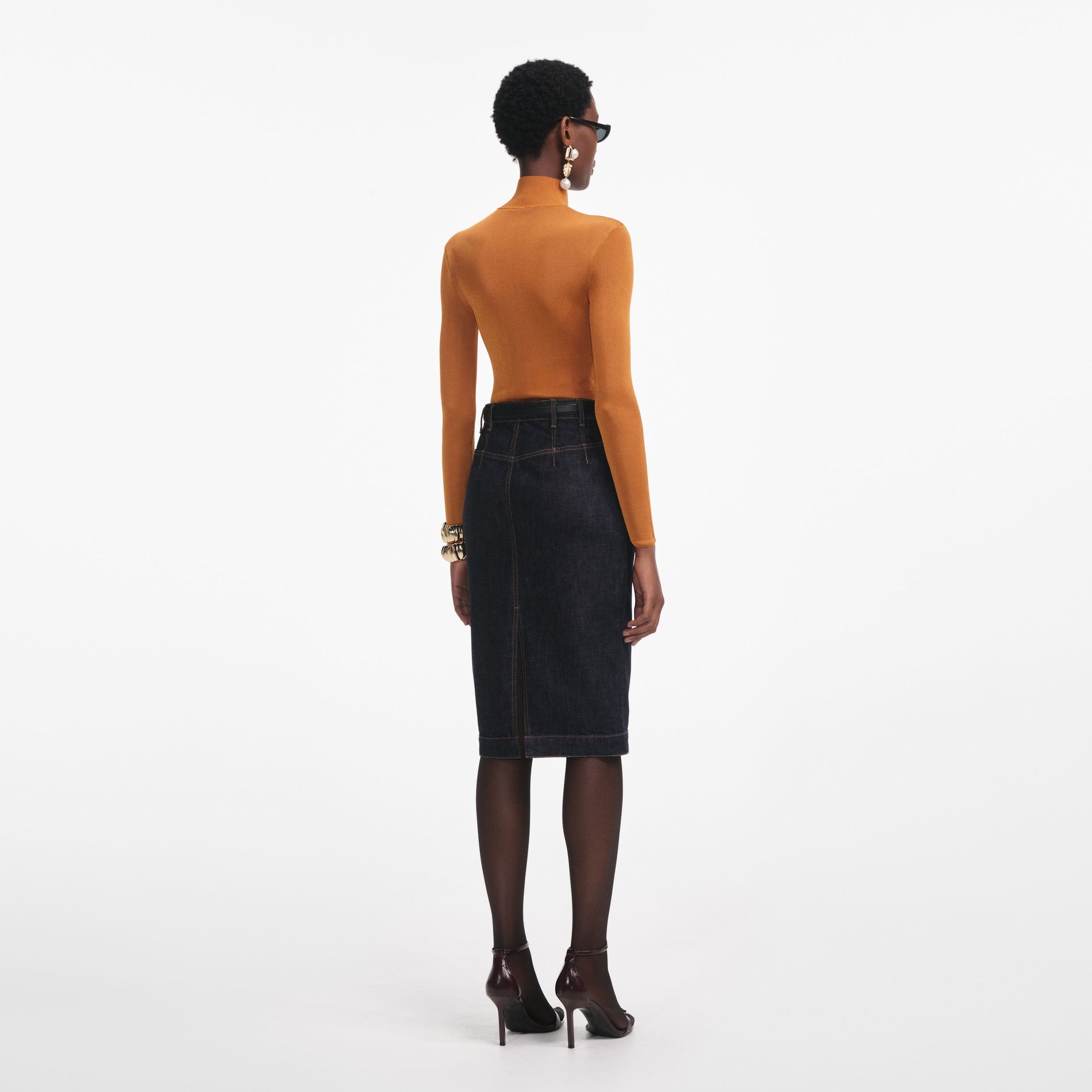 Back view of a woman wearing the Burnt Orange Viscose Knit Top