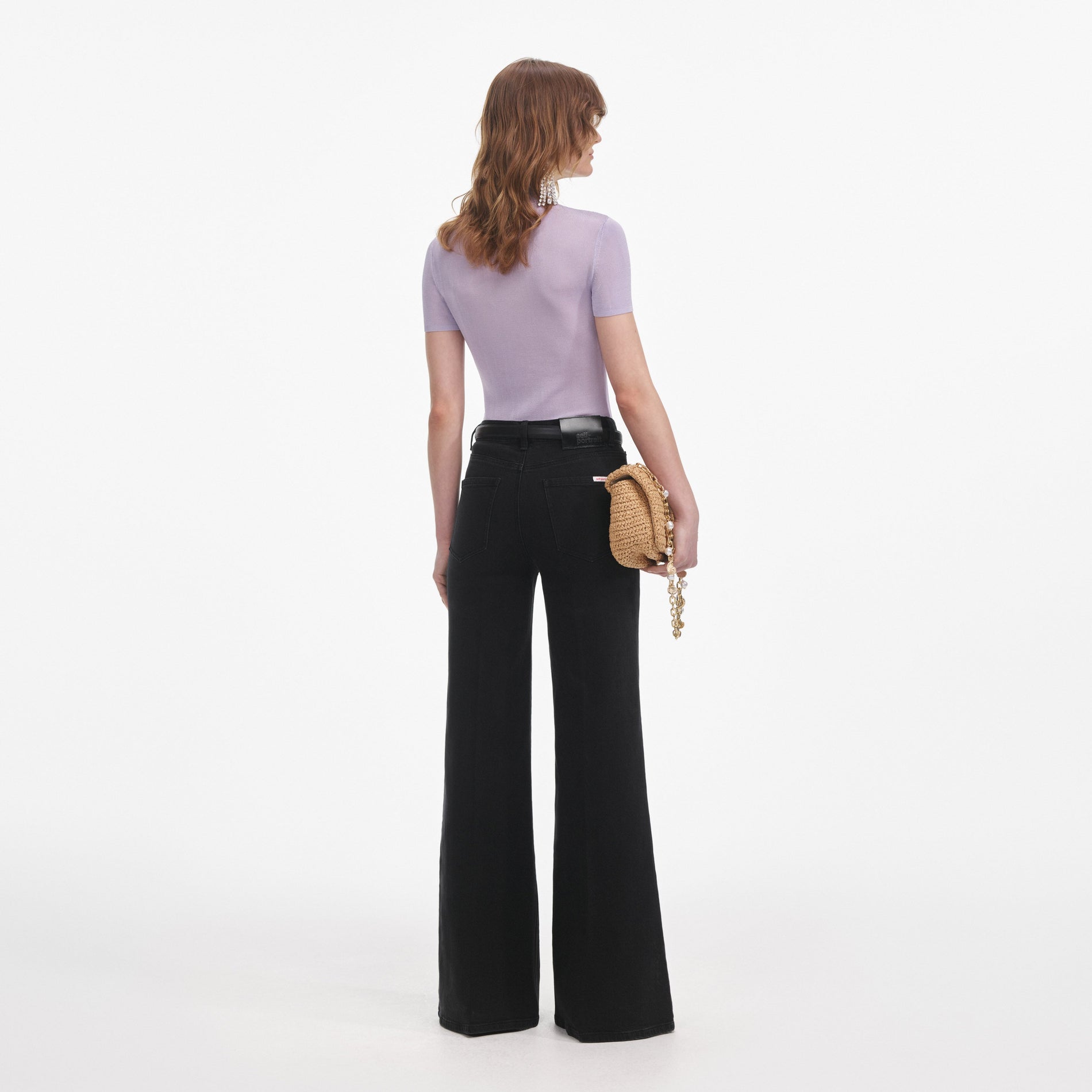 Back view of a woman wearing the Lilac Viscose Knit Short Sleeve Top